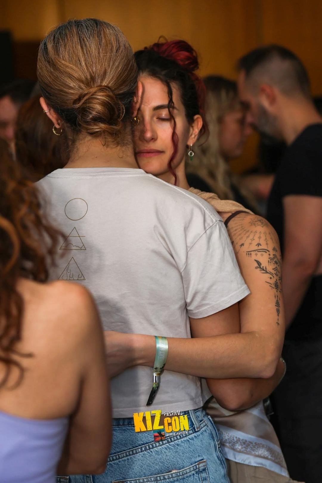 two women dancing douceur in closed embrace soft lighting eyes closed connection