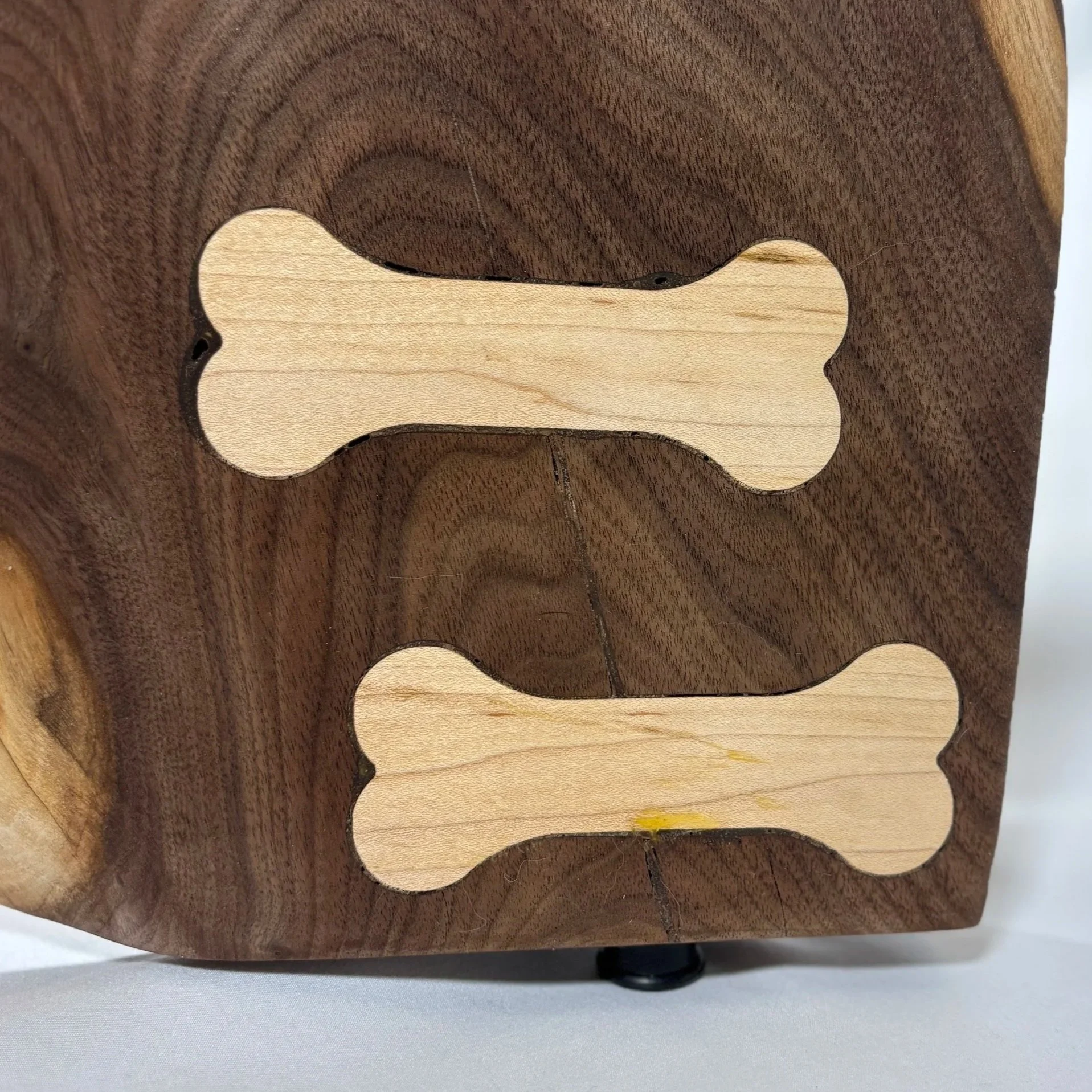 Dog bones as bow ties, a structural necessity to stabilize cracks in wood