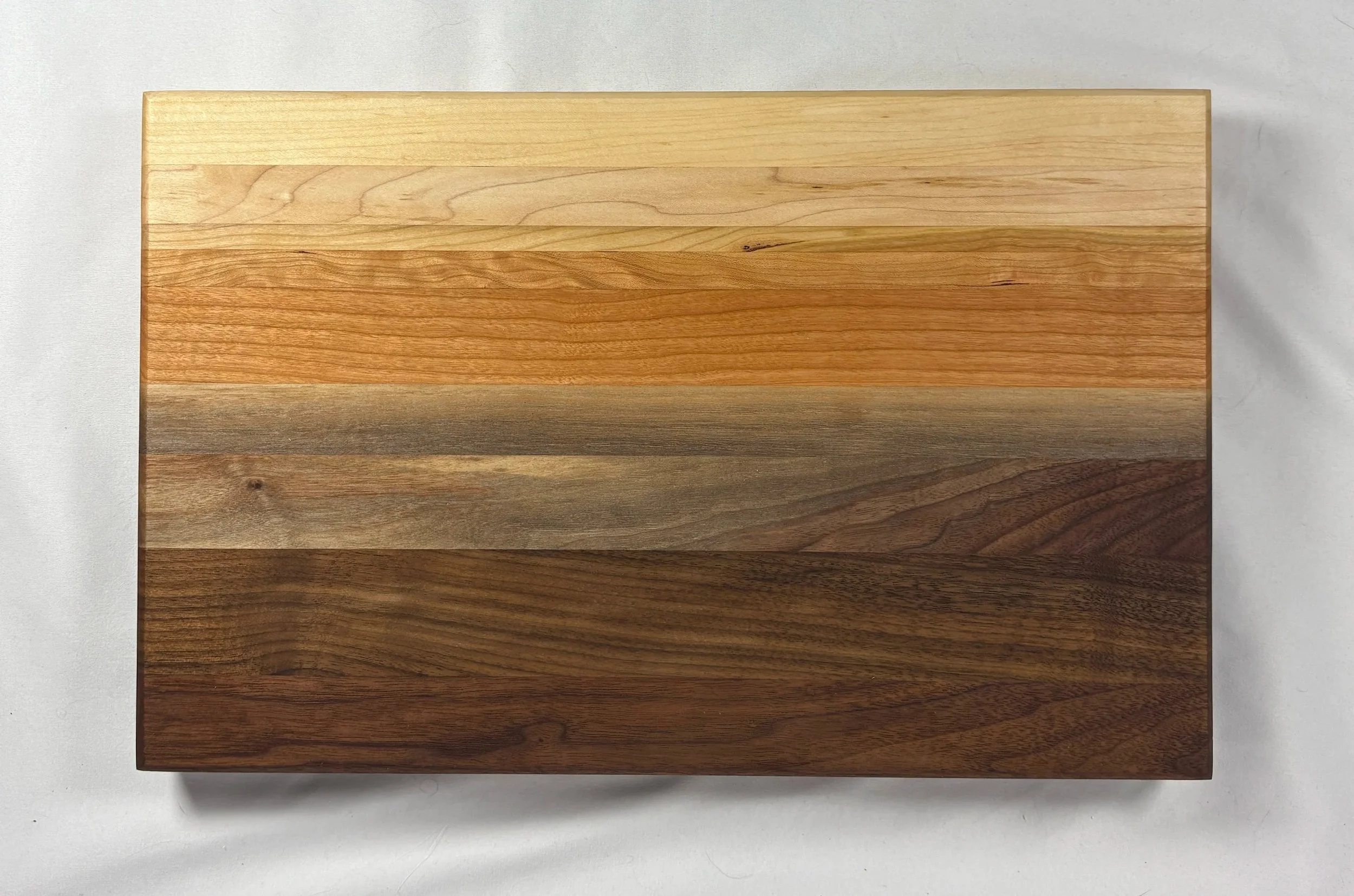 12" x 18" Rainbow board. No stains or dyes. Pattern created by mixing different woods. 