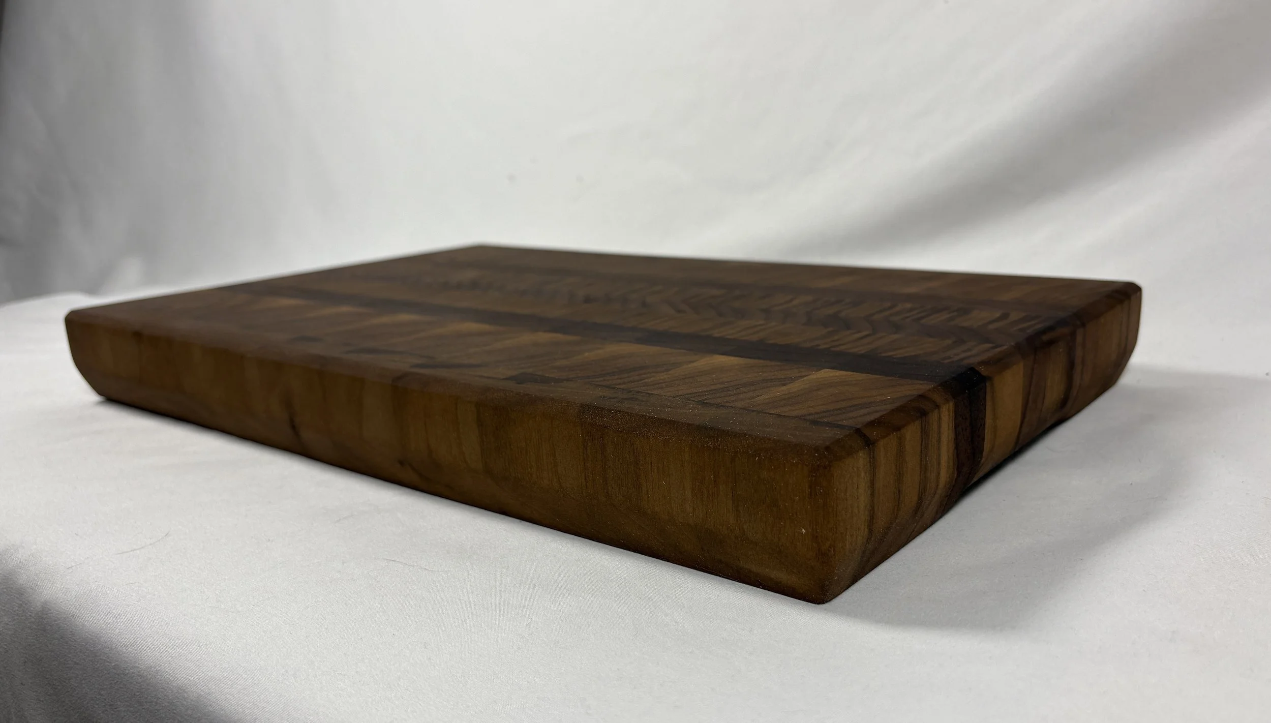 12" x 18" Butcher Block, 22 degree chamfer along the bottom to act as a handle without significantly reducing board space.