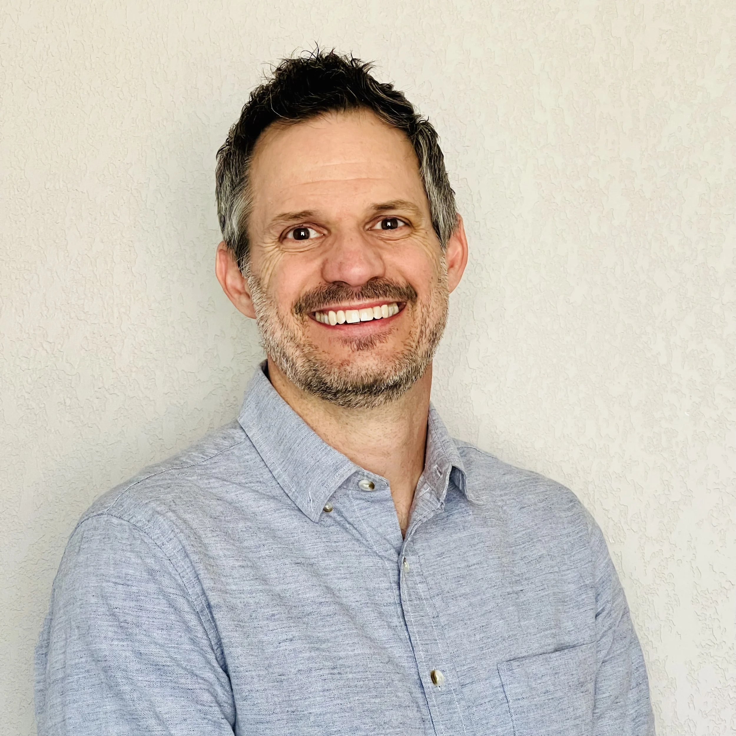 Tacoma therapist Justin Mootz, LMFTA, smiling and offering a welcoming presence for individuals, couples, and families.