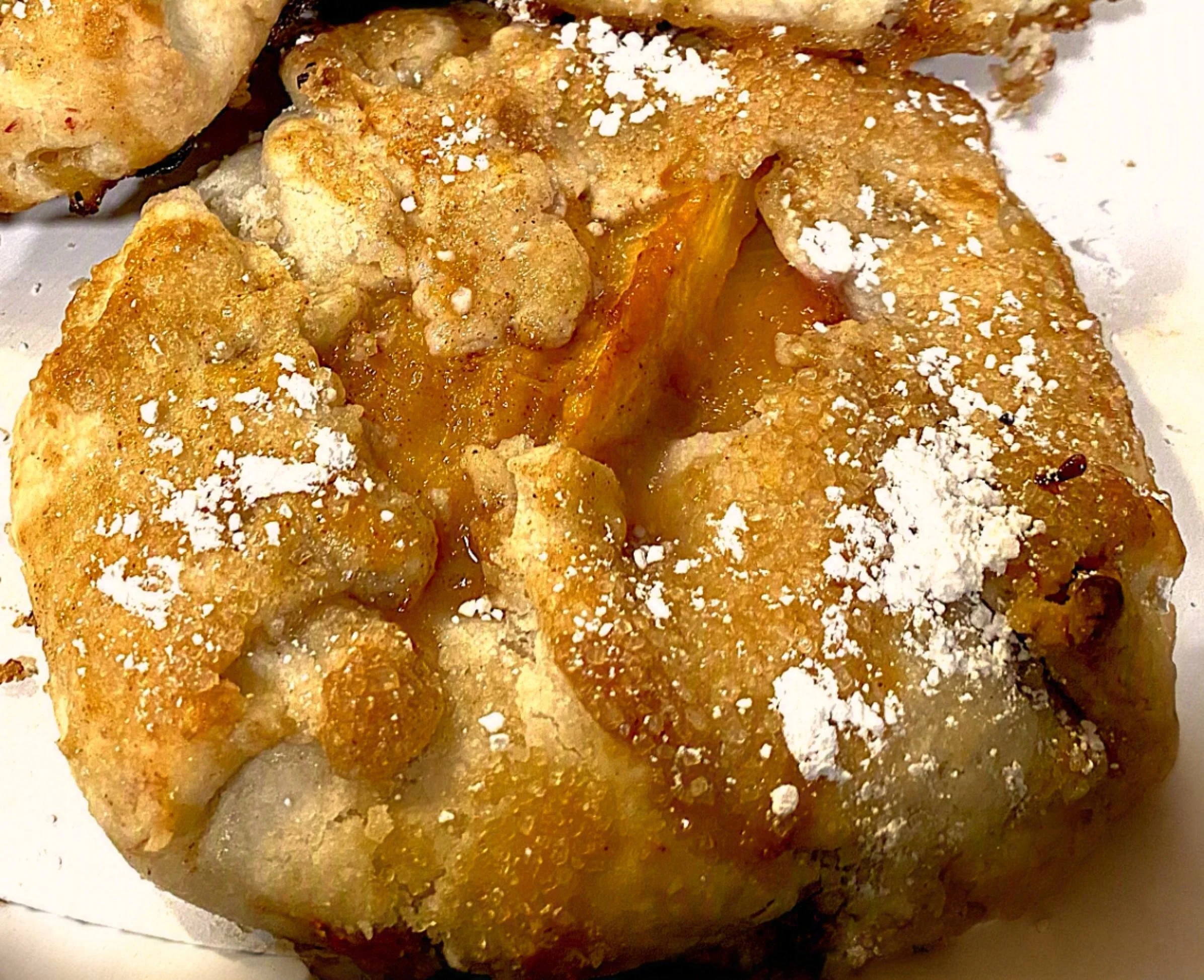 Flaky, all-butter pastry folded by hand around a generous filling of juicy local peaches, lightly spiced with cinnamon, then baked until golden and crisp. Rustic, buttery, and bursting with sweet summer peach flavor in every bite.