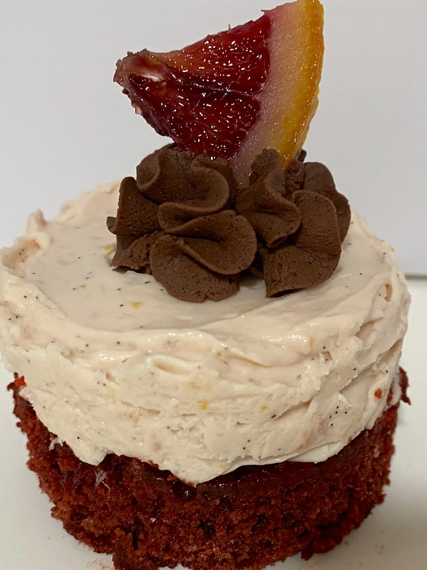 Mini Red Velvet Cake Blood Orange Mousse. Garnished - Choc. Ganache Swirl and Candied Blood Orange Section.