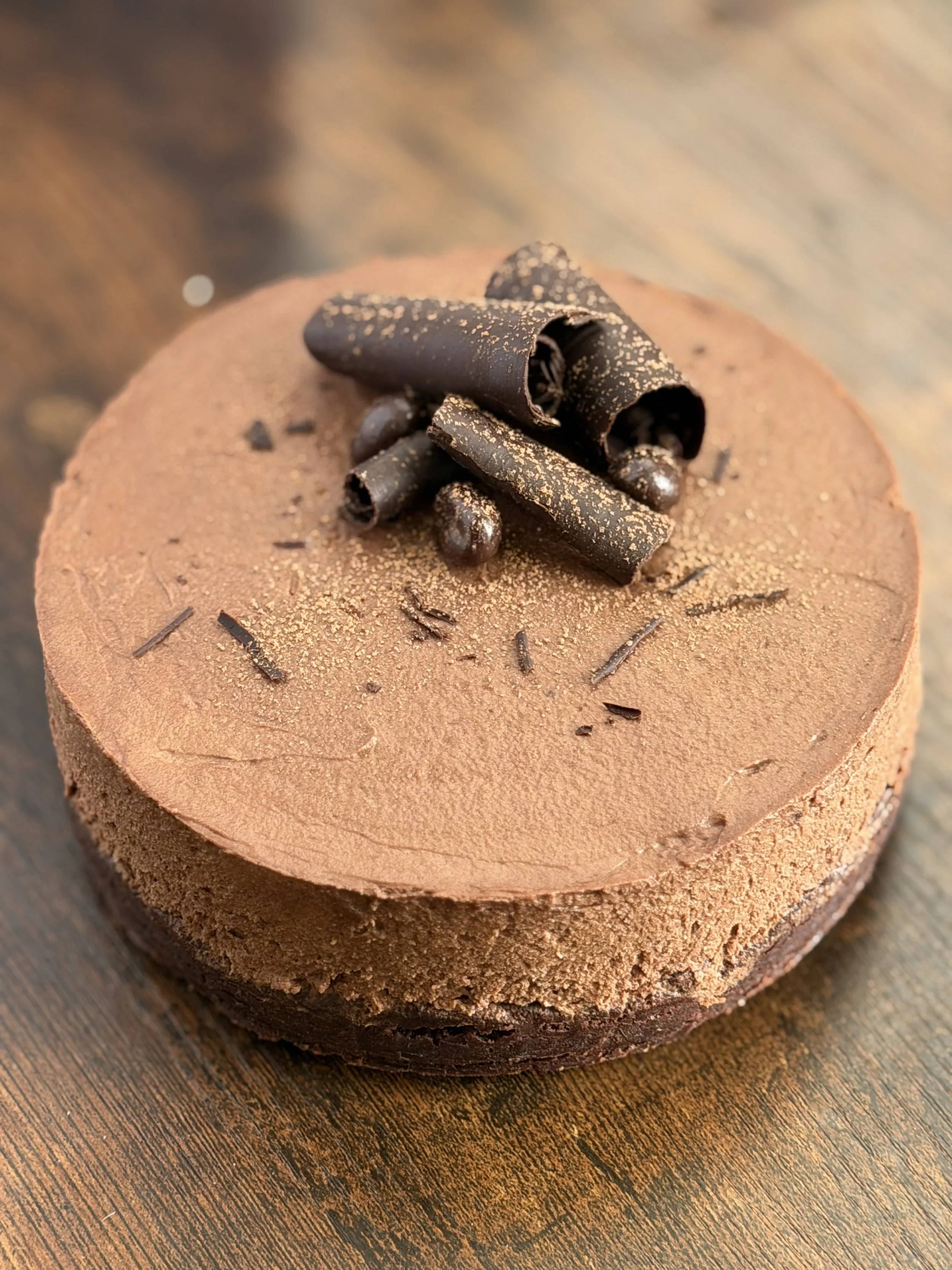 Fudge Brownie Cake layered with Chocolate Espresso Mousse - 6 inch.  A rich chocolate dessert featuring a dense brownie base topped with silky espresso chocolate mousse made with premium chocolate.