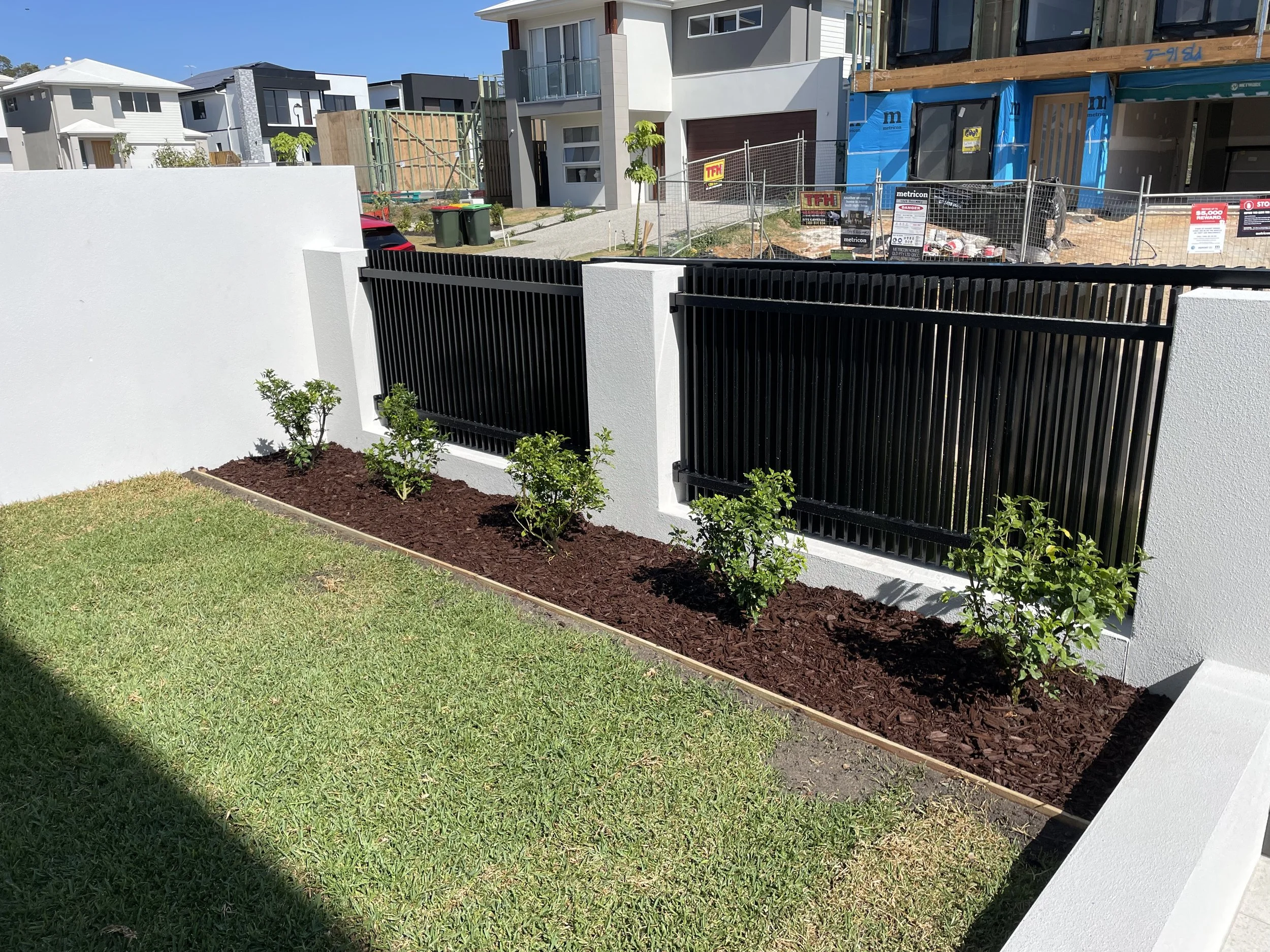 Custom-built front yard with sliding driveway gate - Brisbane landscaping project