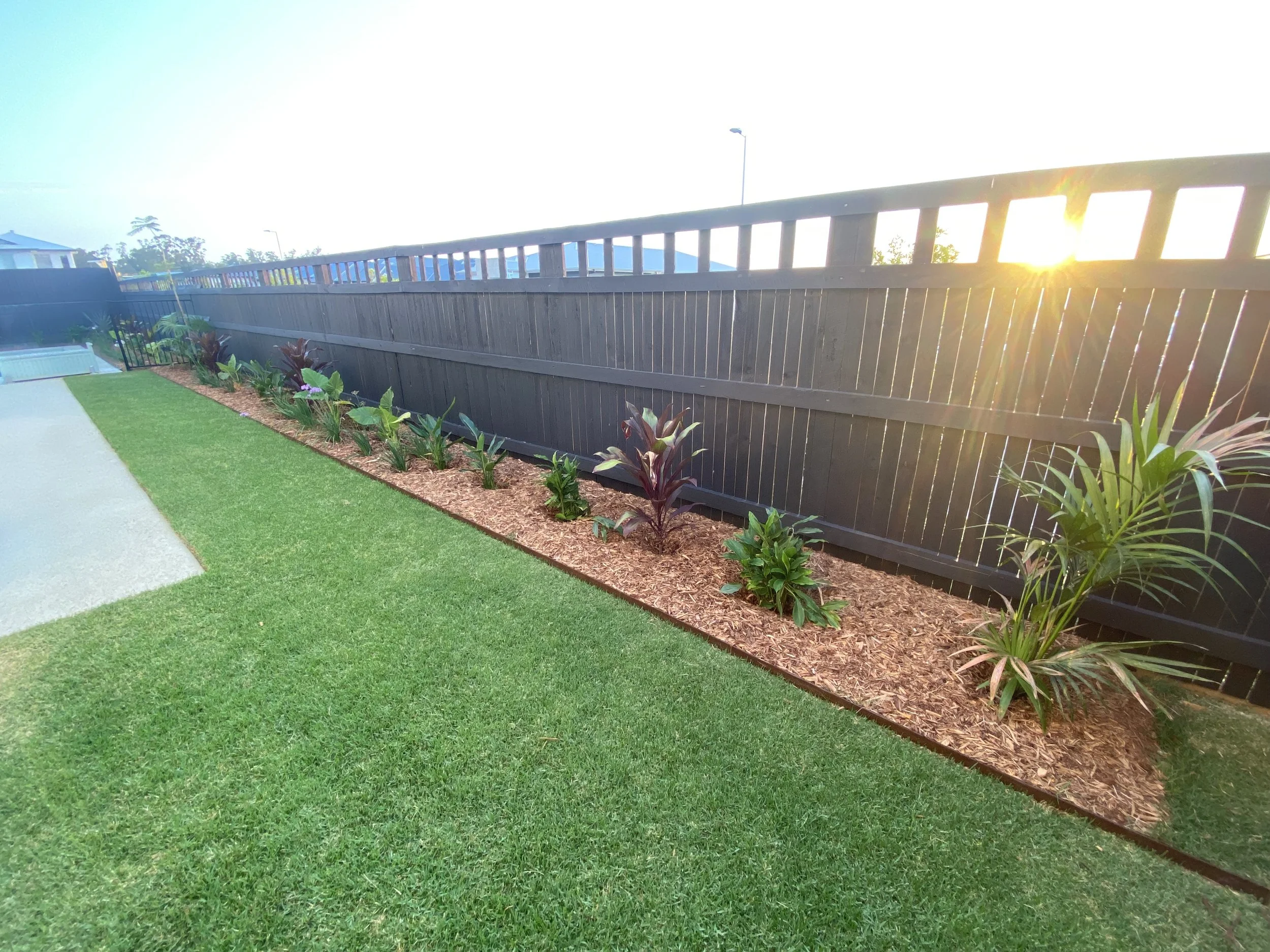 Outdoor entertaining area with illuminated pool and modern stone steps - Landscape design and build in Brisbane