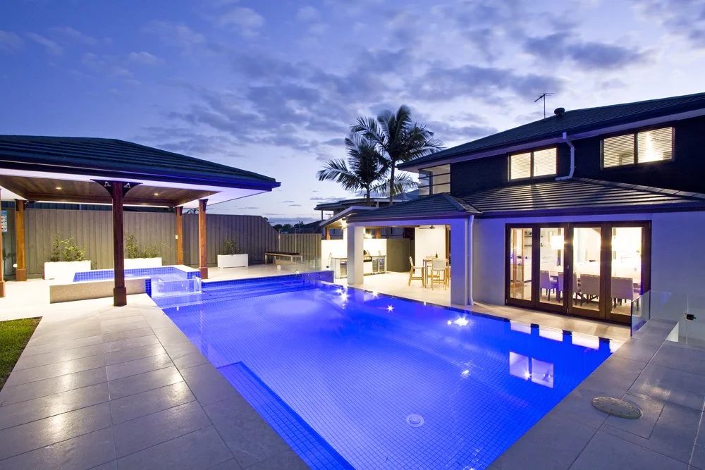 Outdoor entertaining area with illuminated pool and modern stone steps - Landscape design and build in Brisbane