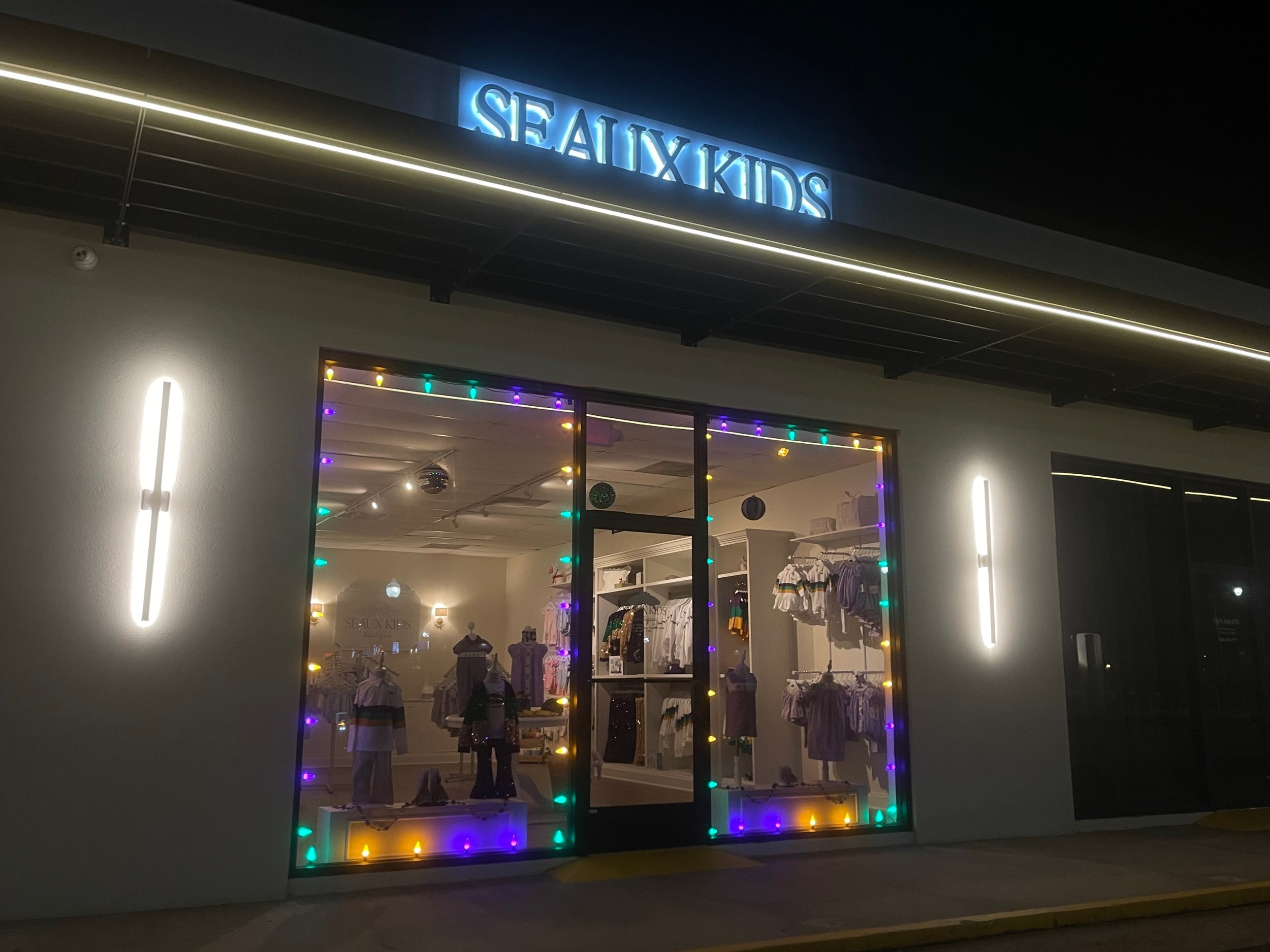 Heritage Lighting Co. brought the spirit of Mardi Gras to life with bold Mardi Gras-themed lighting at SEAUX Kids Boutique, helping the business stand out in Metairie with custom LED displays perfect for the season.