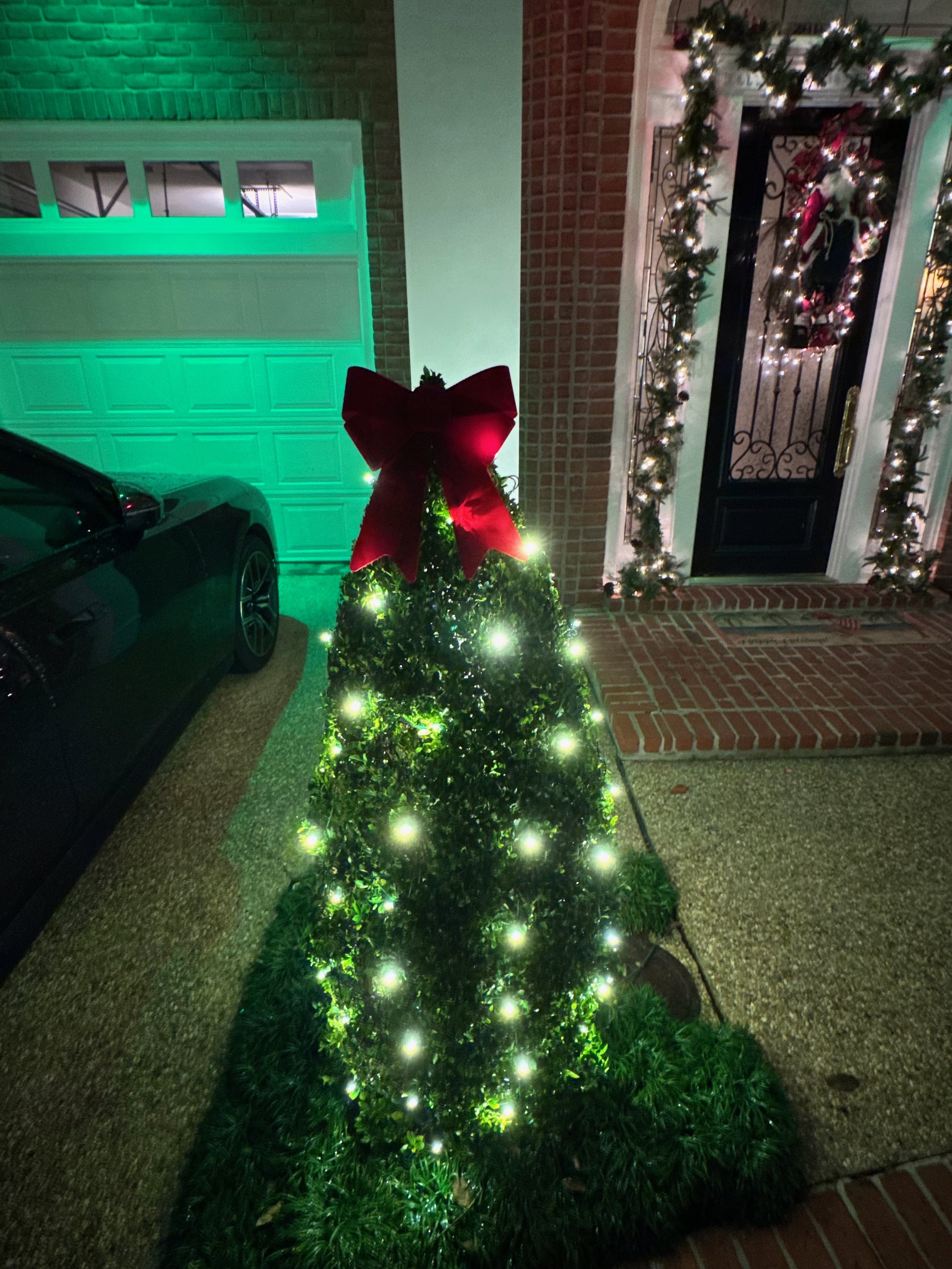 Heritage Lighting Co. wrapped the tree trunks and shrubs at this Old Metairie home with Christmas lights, blending multi-color LEDs with trim lighting along the gutters to create a warm, welcoming holiday atmosphere.