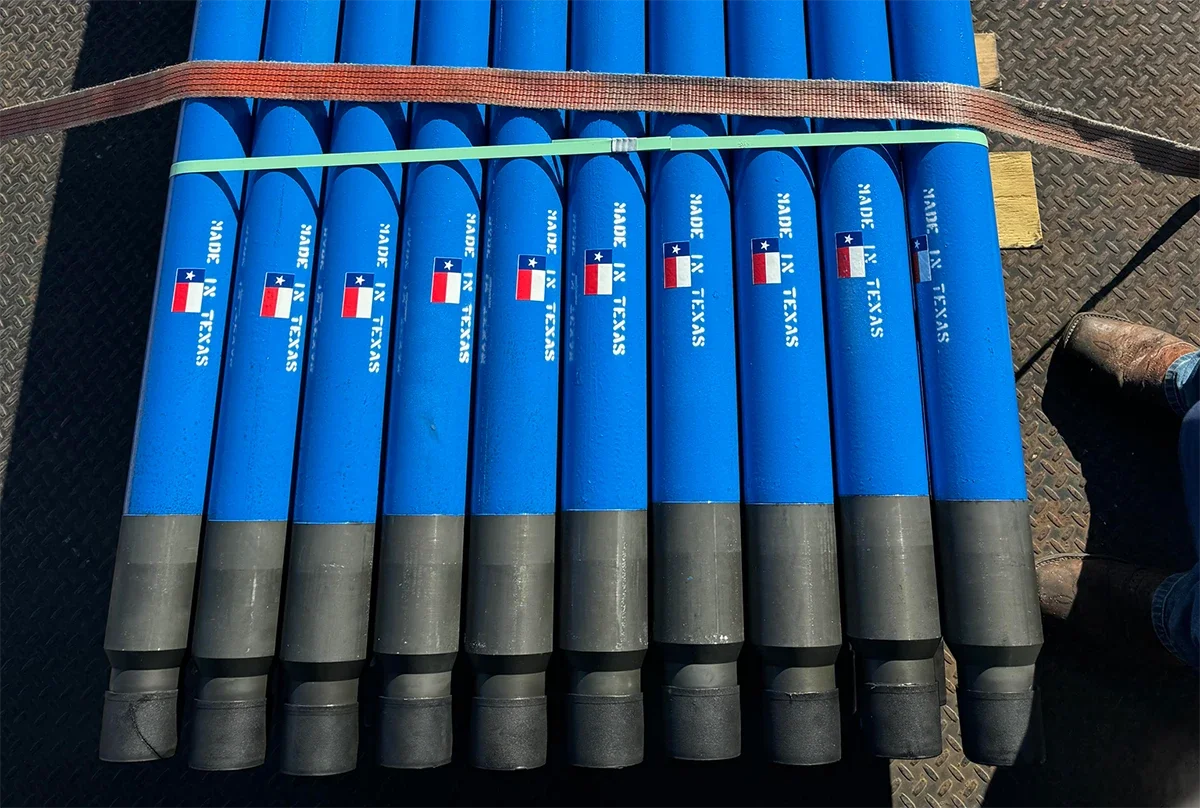 Multiple PetroQuip tools with 'MADE IN TEXAS' and a Texas flag printed on them, strapped together on a flatbed ready for international shipping.