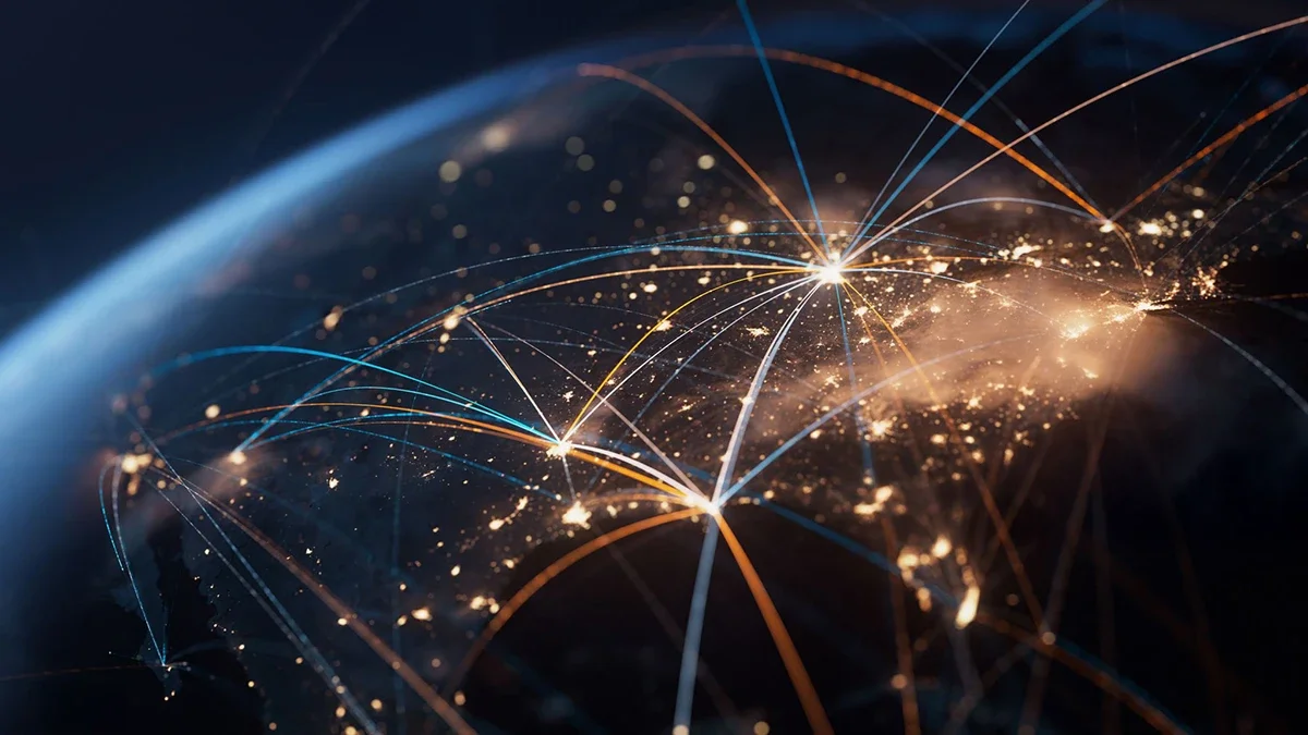 A digital rendering of the Earth at night with illuminated city lights and interconnected glowing lines representing global reach.