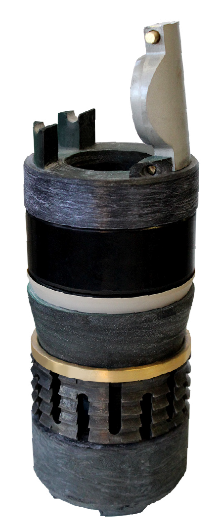 Stack of mechanical or industrial parts, including a metallic clamp, black cylindrical components, foam or rubber rings, and a vascular-like black component.