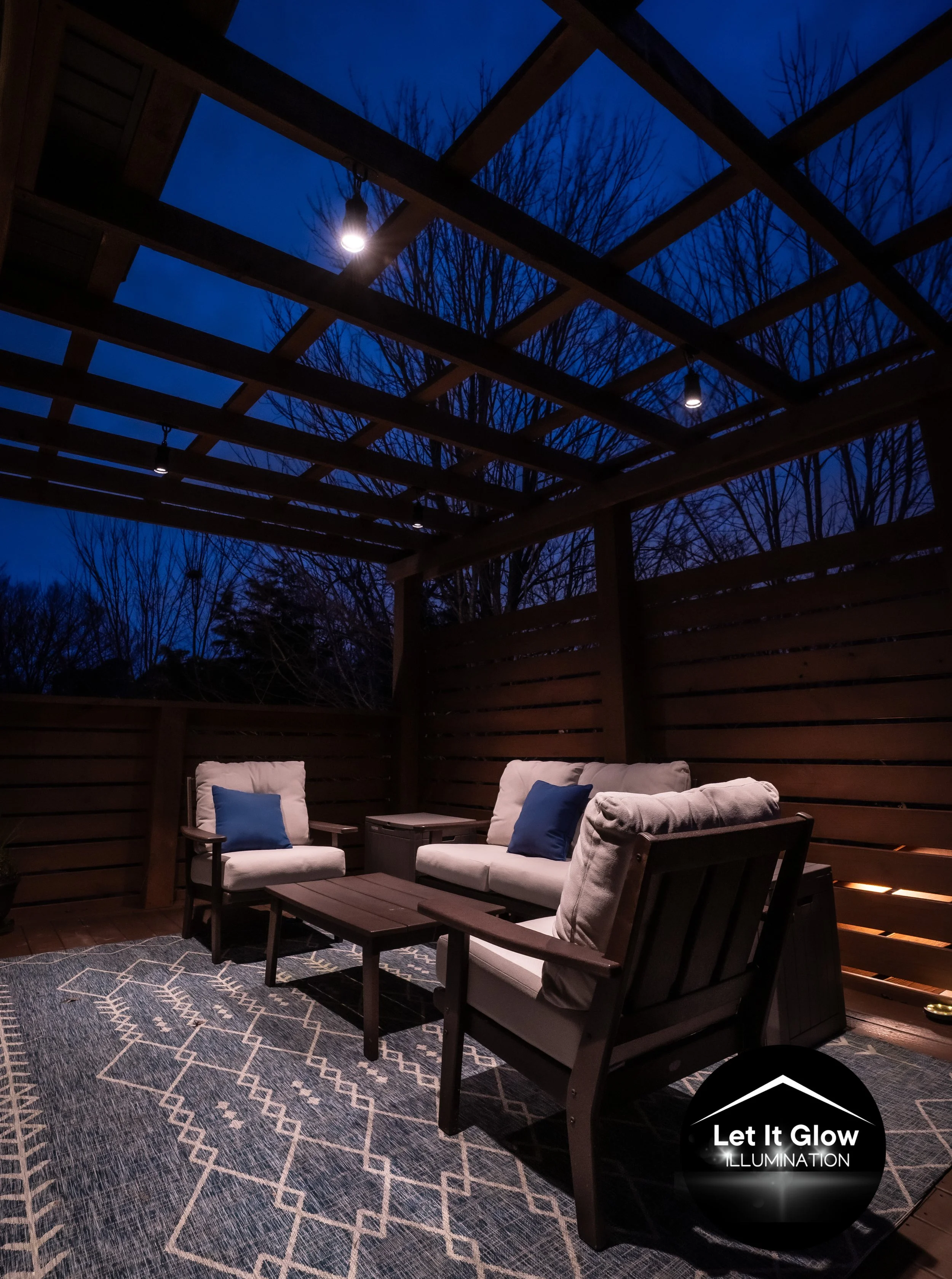 Outdoor audio and patio lighting installation under a wooden pergola in Northwest Arkansas by Premier Outdoor Lighting and Audio