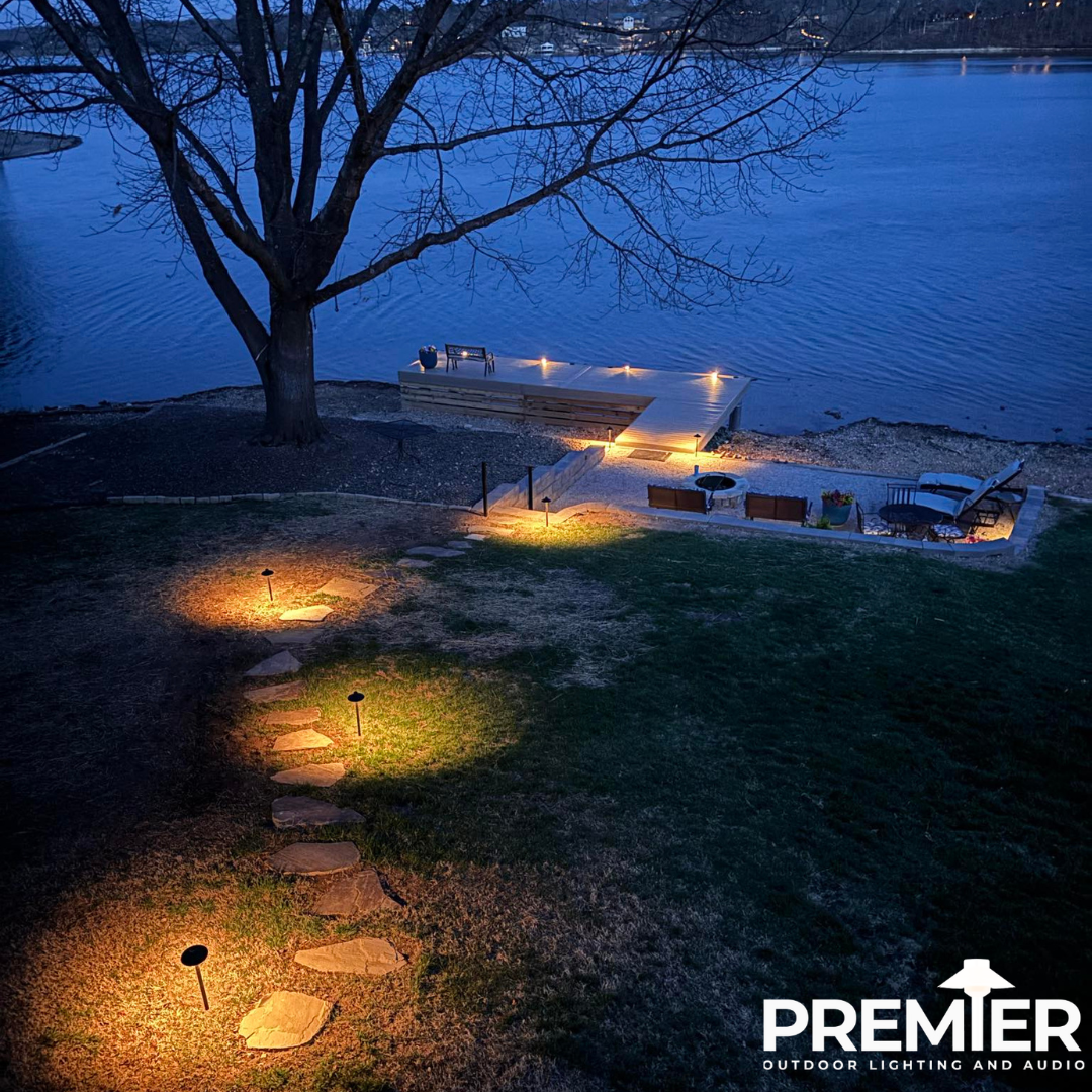 Nighttime landscape lighting along lakefront dock and pathway at Lake Loch Lomond Bella Vista Arkansas by Premier Outdoor Lighting and Audio