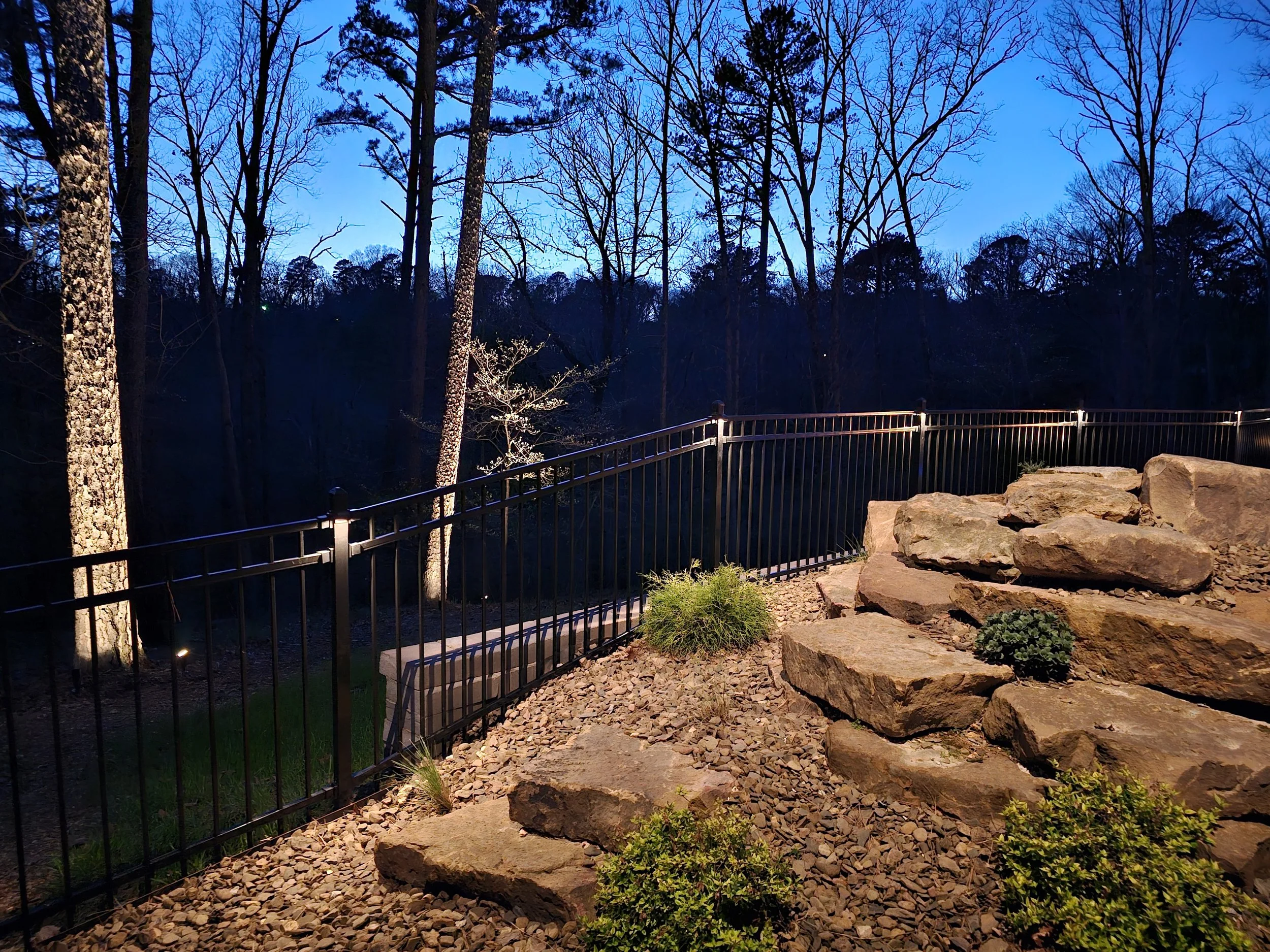 Natural rock landscape lighting with boulder uplights at dusk in Northwest Arkansas.jpg