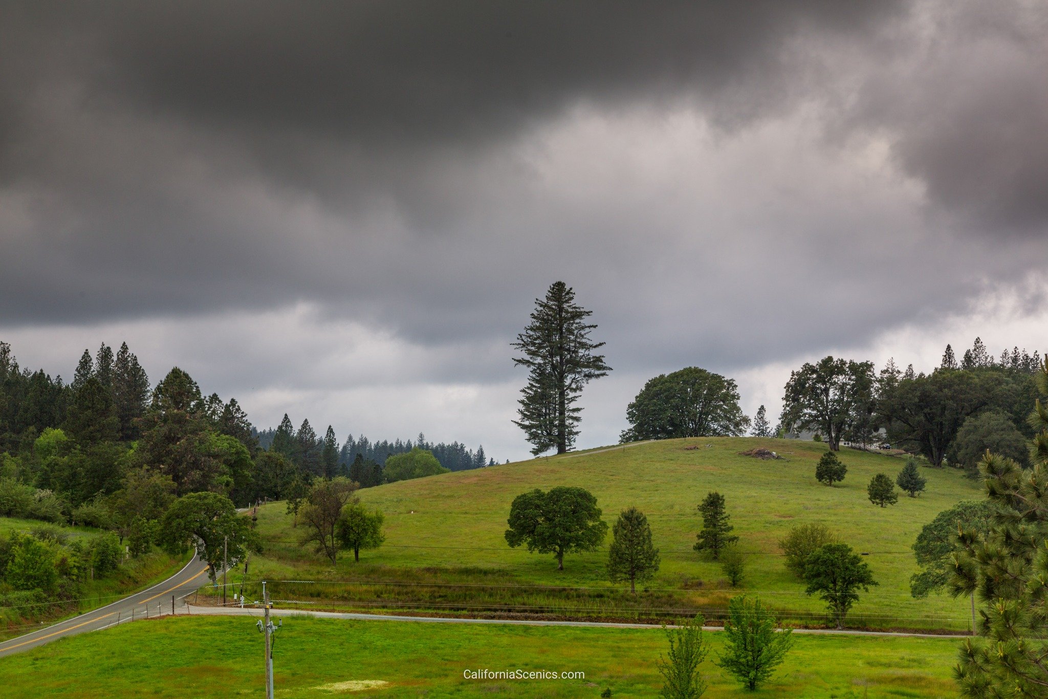 Dramatic clouds hang over a scenic part of Northern California's rolling hills.