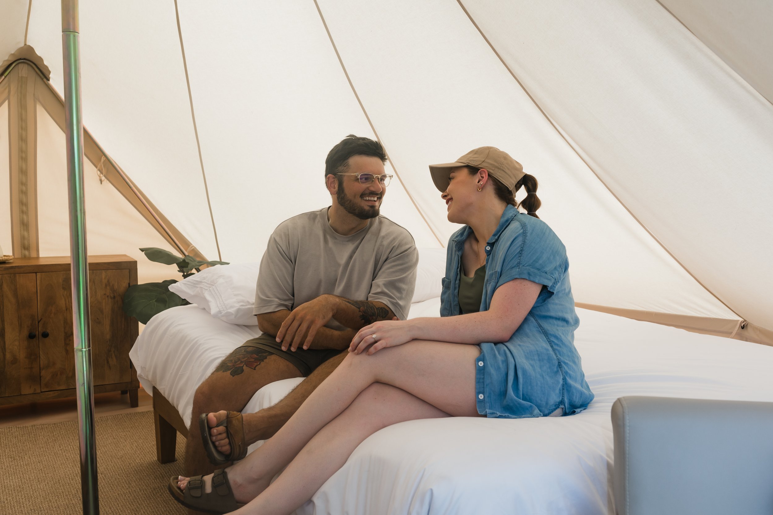 Couple enjoying a luxury glamping experience inside a canvas tent at Bayou Glamping Co. in Southwest Louisiana, Lake Charles