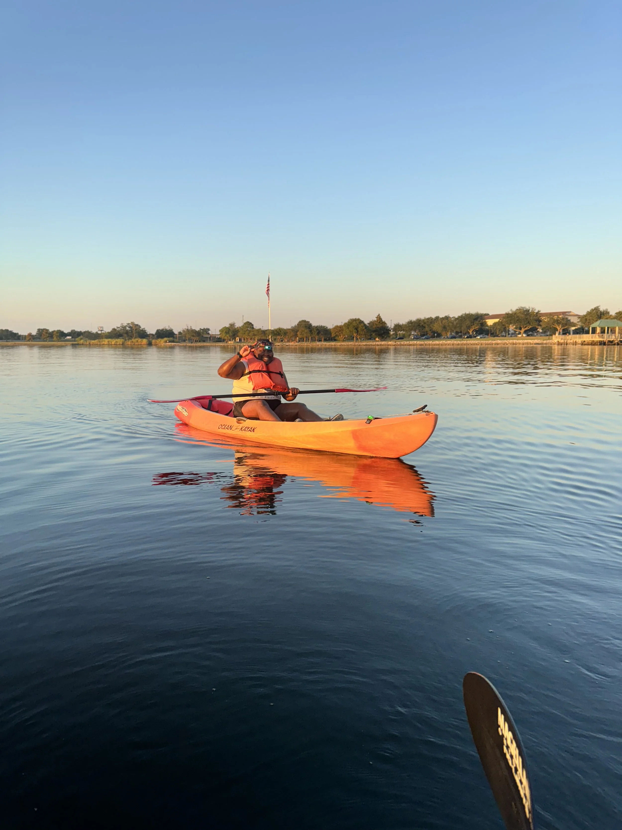 a solo paddler enjoys a peaceful kayaking experience on Lake Charles, a calm Southwest Louisiana waterway. Bayou Glamping Co. offers single kayak rentals, guided tours, and outdoor adventures near Lake Charles, providing unforgettable explorations.