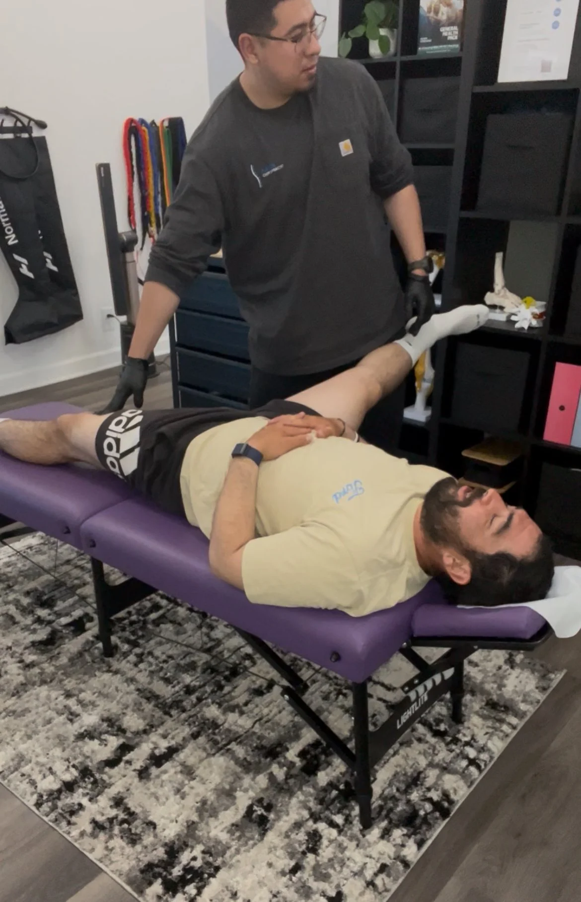 A man having his legs stretched by a chiropractor. Located in encino california.