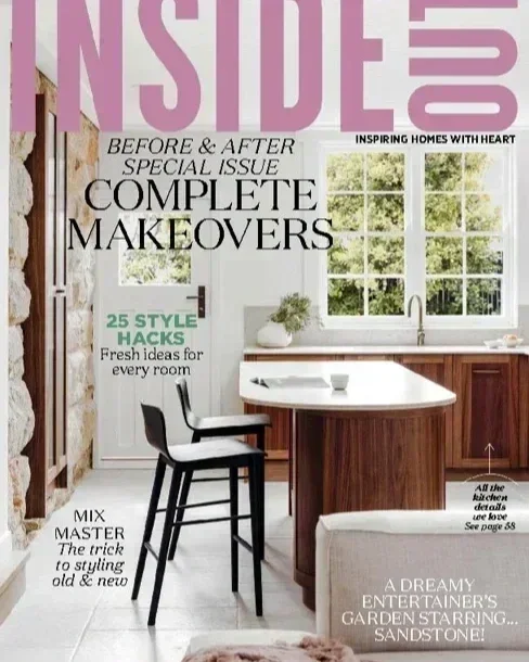 Cover of a home decor magazine featuring a bright kitchen with a white sink, wooden cabinets, and two large windows, with headlines about home makeovers and decorating tips. Evie Adasal artist featured in media as contemporary .