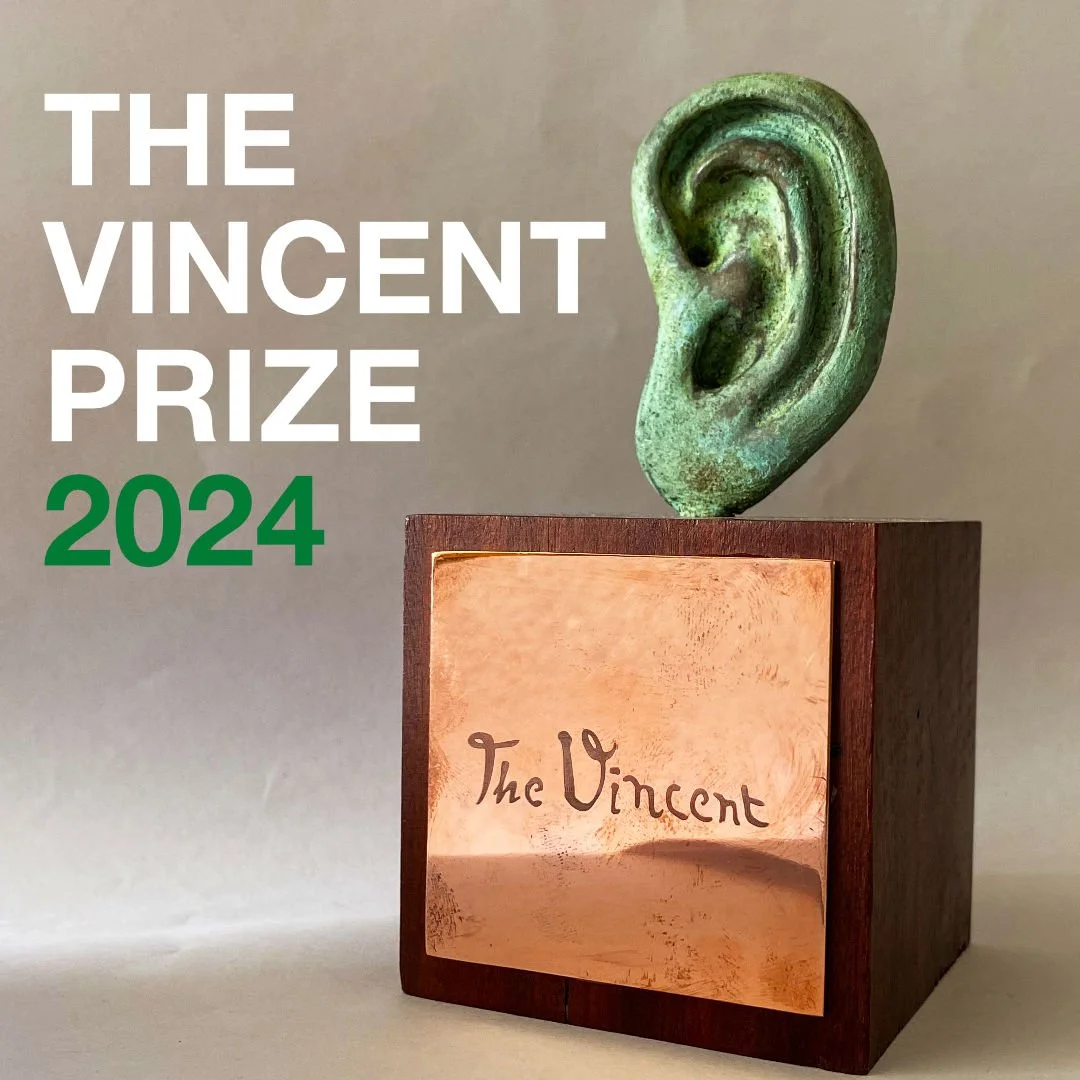 A bronze sculpture of an ear on a wooden base with a plaque that reads 'The Vincent'. The image includes text that says 'The Vincent Prize 2024' in white and green font. award winning artist