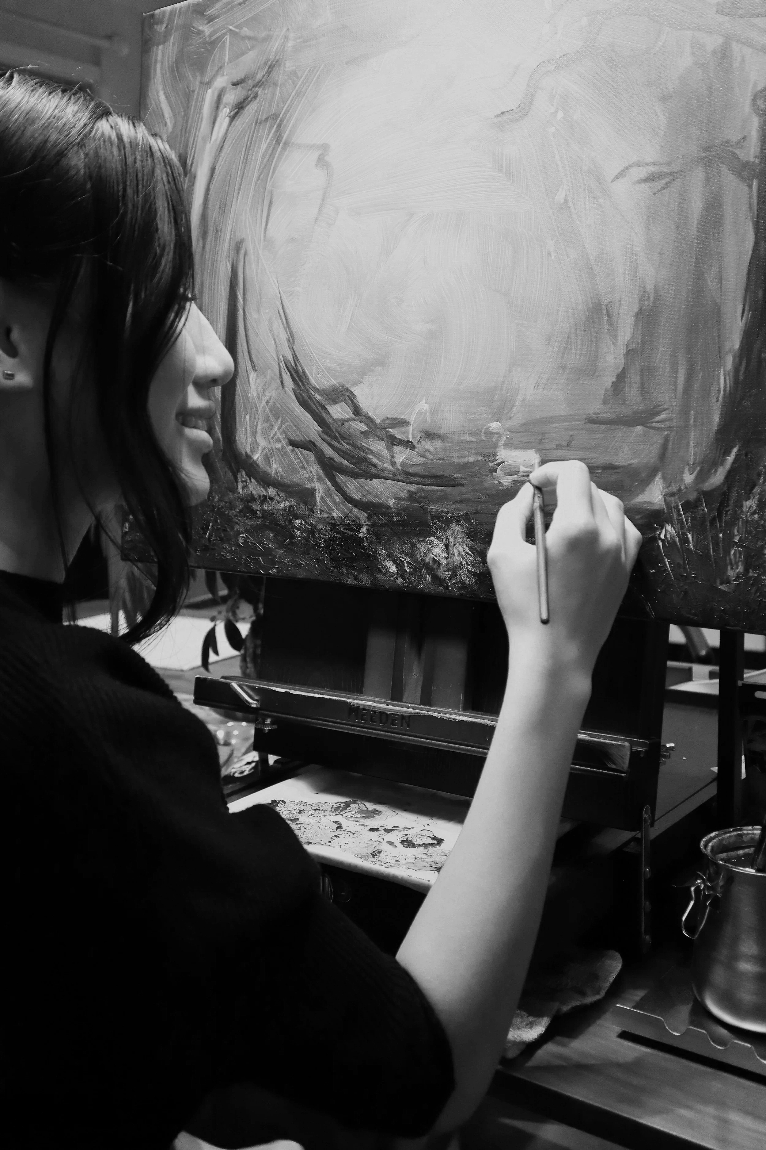Artist Brigitte of Lettered Atelier painting on canvas