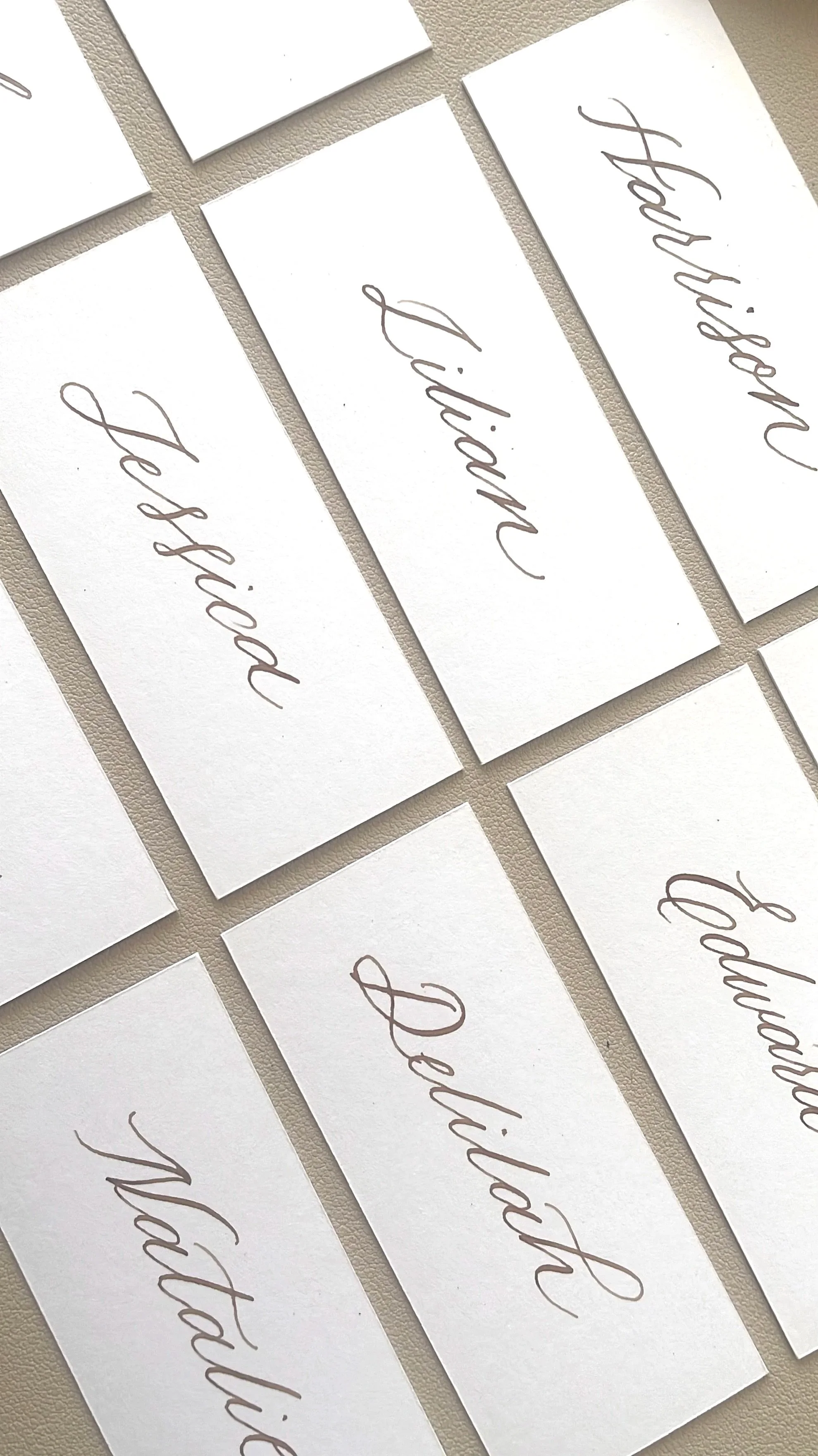 Wedding placecards handwritten calligraphy in brown maple colour