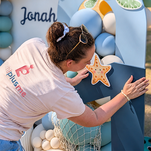 Mini Plus Me owner setting up a branded party display