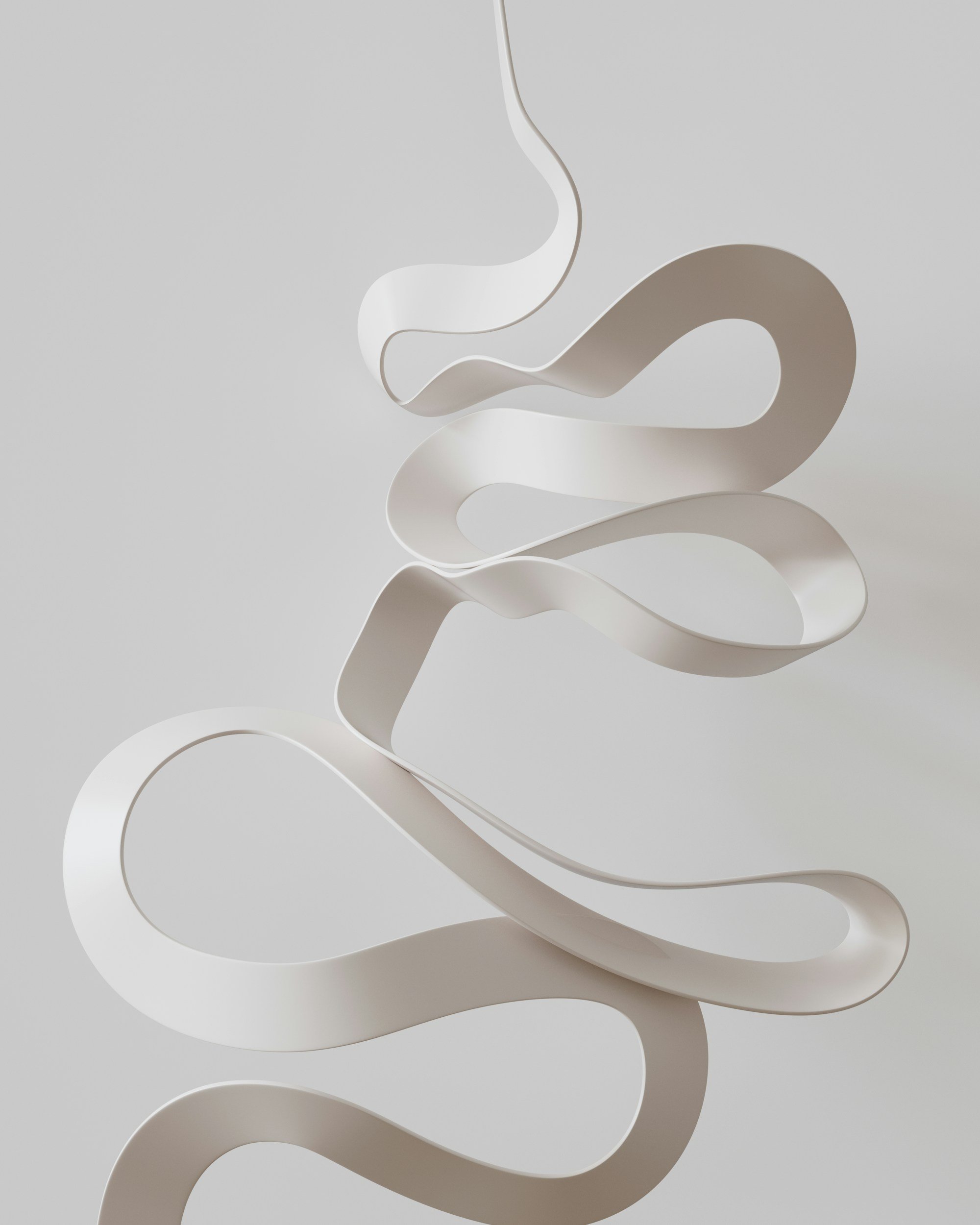 Abstract sculpture made of white, flowing ribbon-like material with curves and loops.