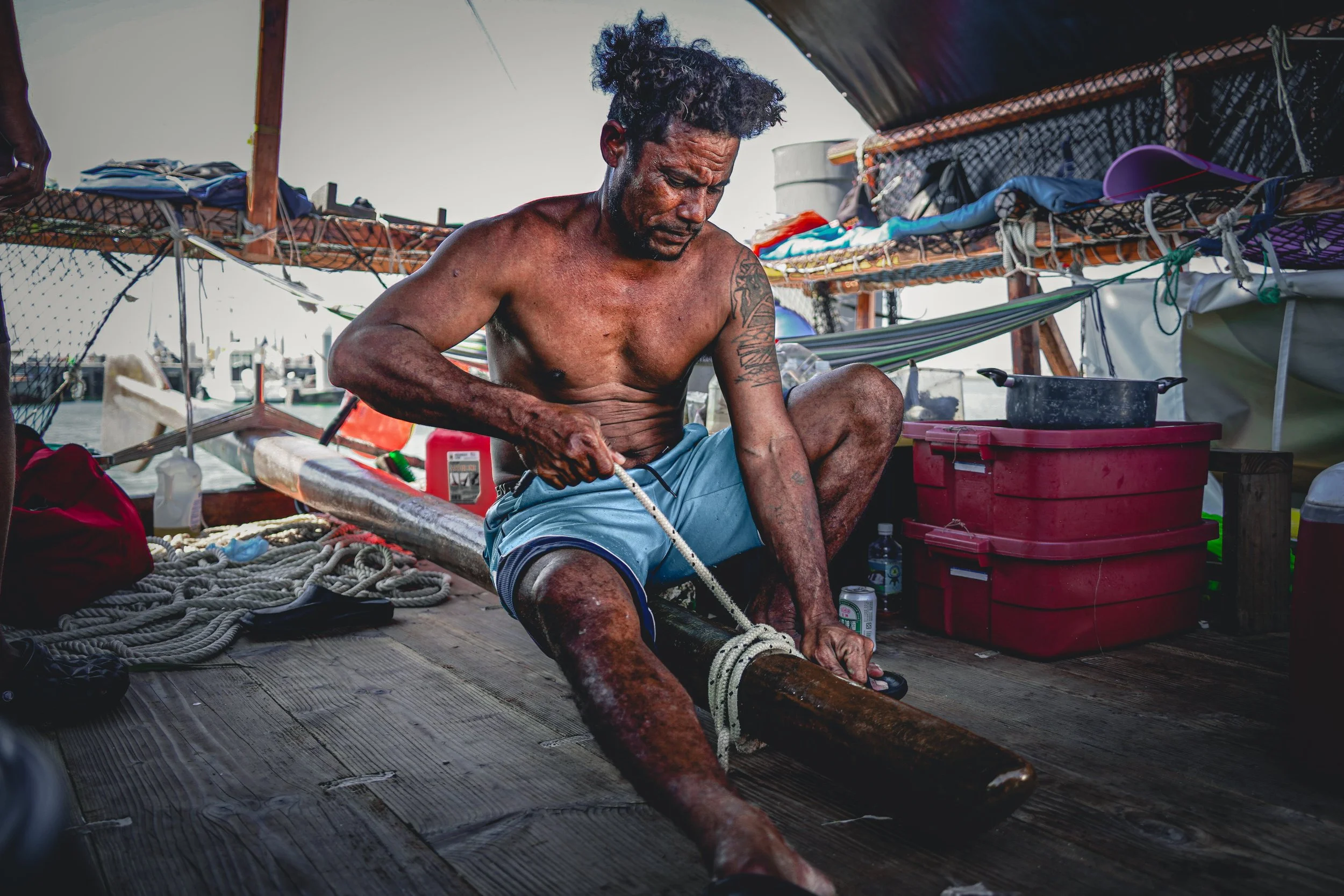 Ismael Tewalmai, 40, a veteran crew member from the Federated States of Micronesia, securing the Hoi aboard the voyaging canoe while docked in Taiwan. Photo by Chuan-Jung Teng, Master’s Program, National Sun Yat-sen University (@pilot_cliff)..JPG