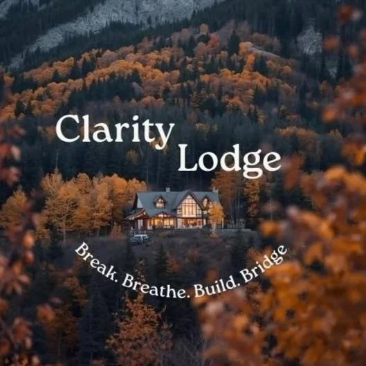 A cozy lodge surrounded by autumn trees with orange and yellow leaves, with the text 'Clarity Lodge' and the phrase 'Break. Breathe. Build. Bridge.'