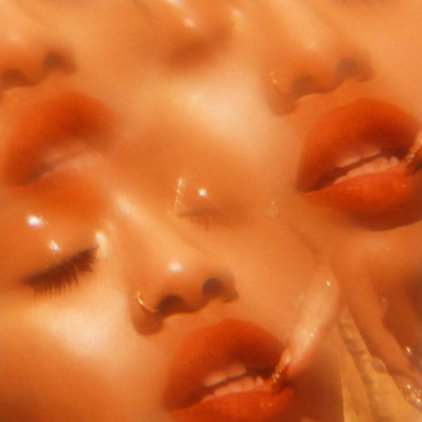 Close-up of three gold Chinese zodiac statues with faces, eyes closed, and mouths slightly open.