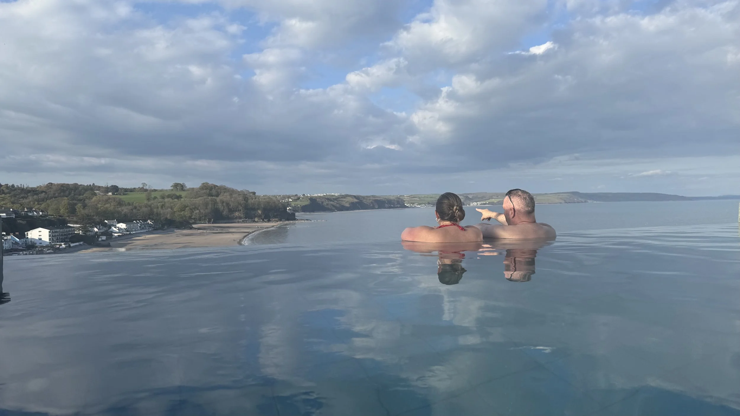  holiday makers relaxing in an infinity pool in Wales 