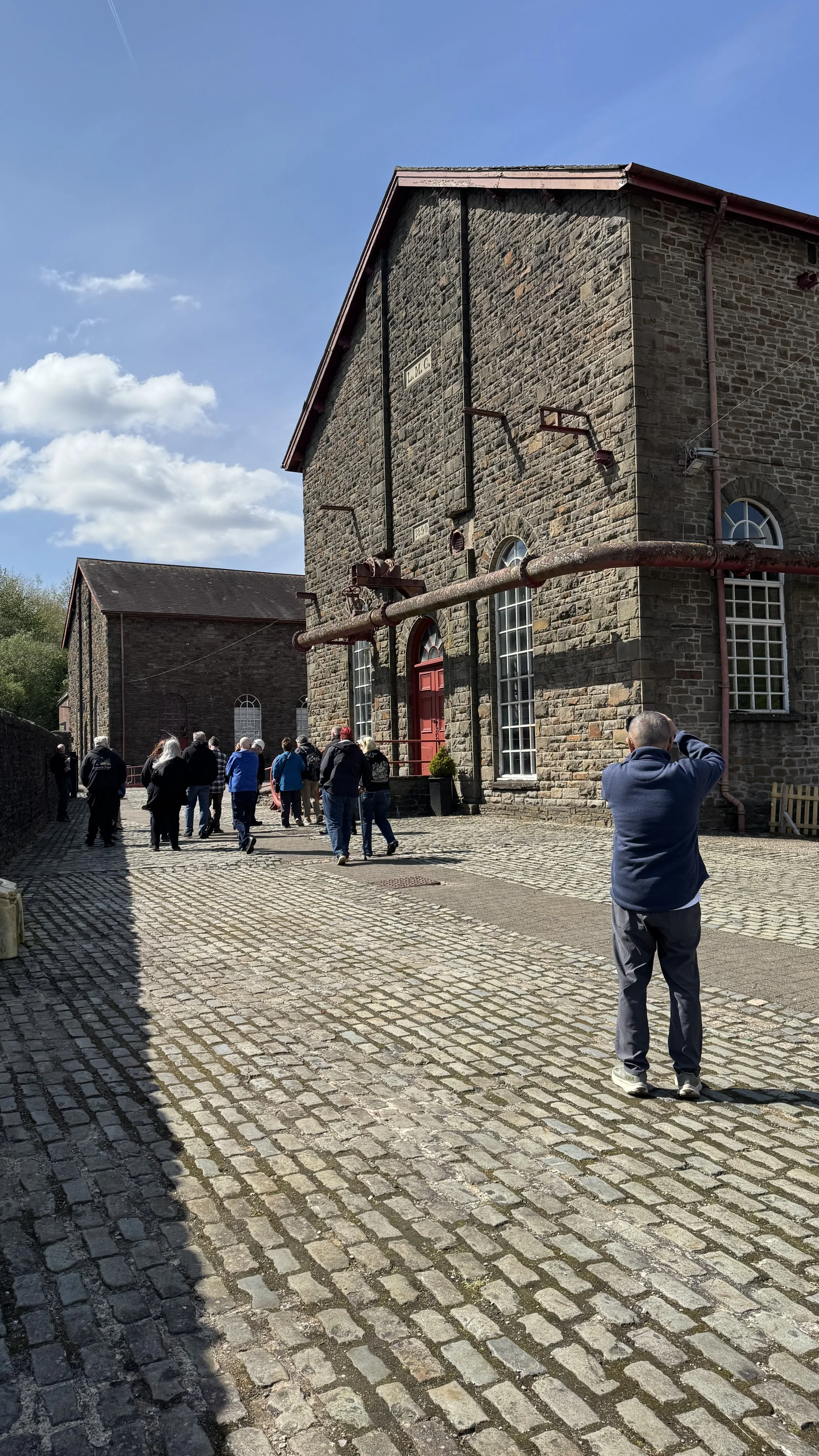  a group of holiday makers on a guided tour of the Rhonda Heritage Museum 