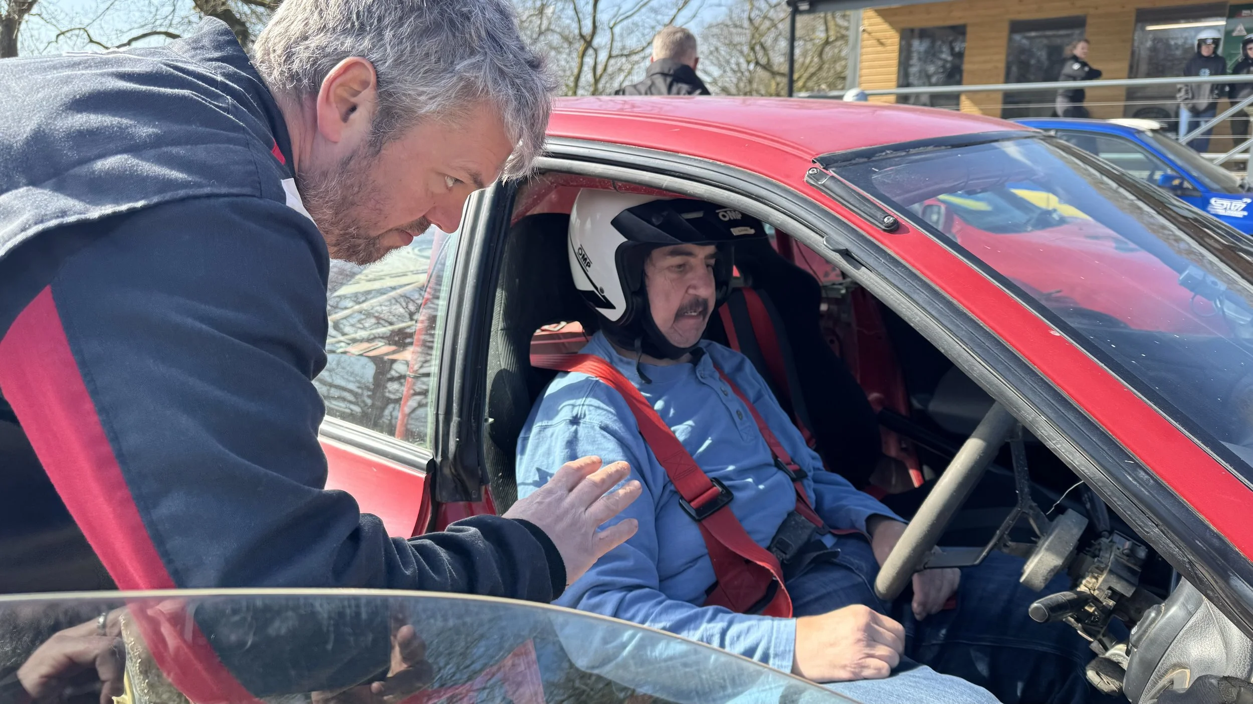 a student sitting in a rally car 