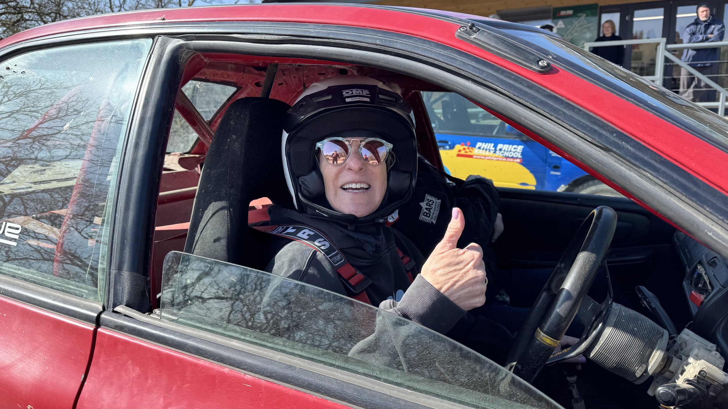  a happy person in a rally car 