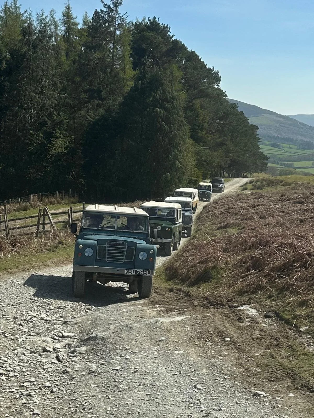  a convoy of classic land rovers on a tour across Wales 