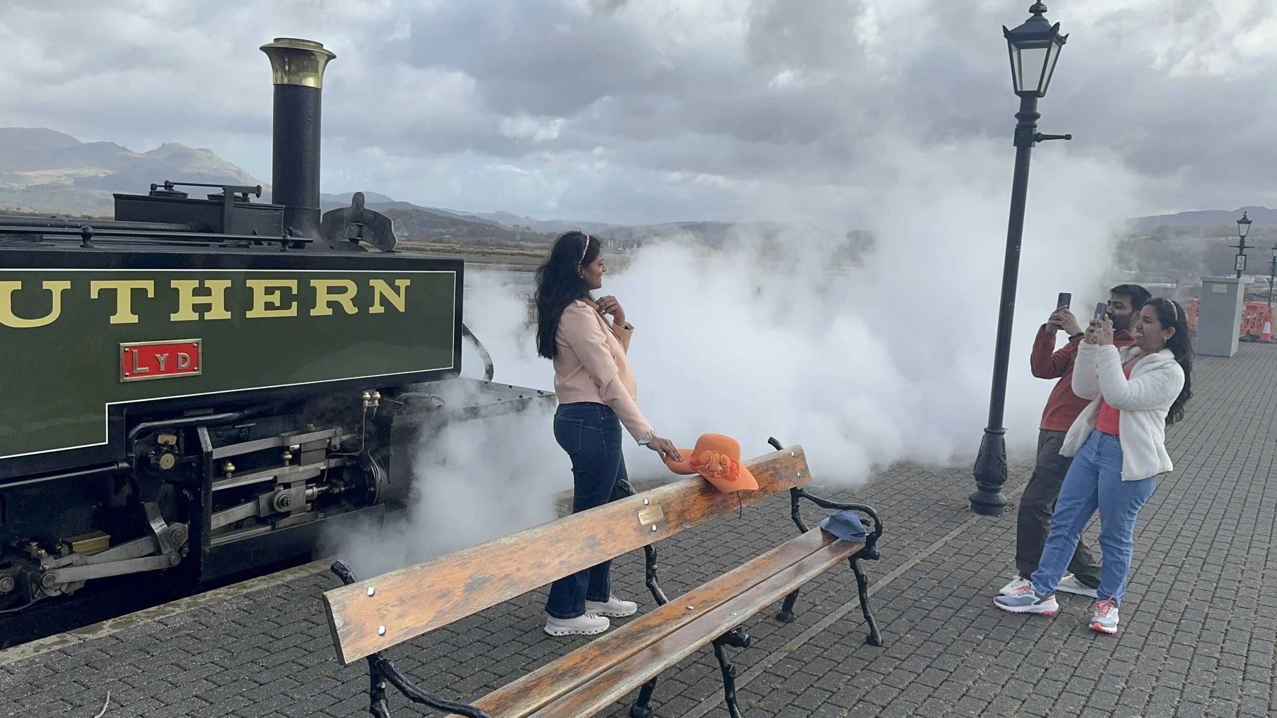 Steam train with smoke leaving Portmadog station
