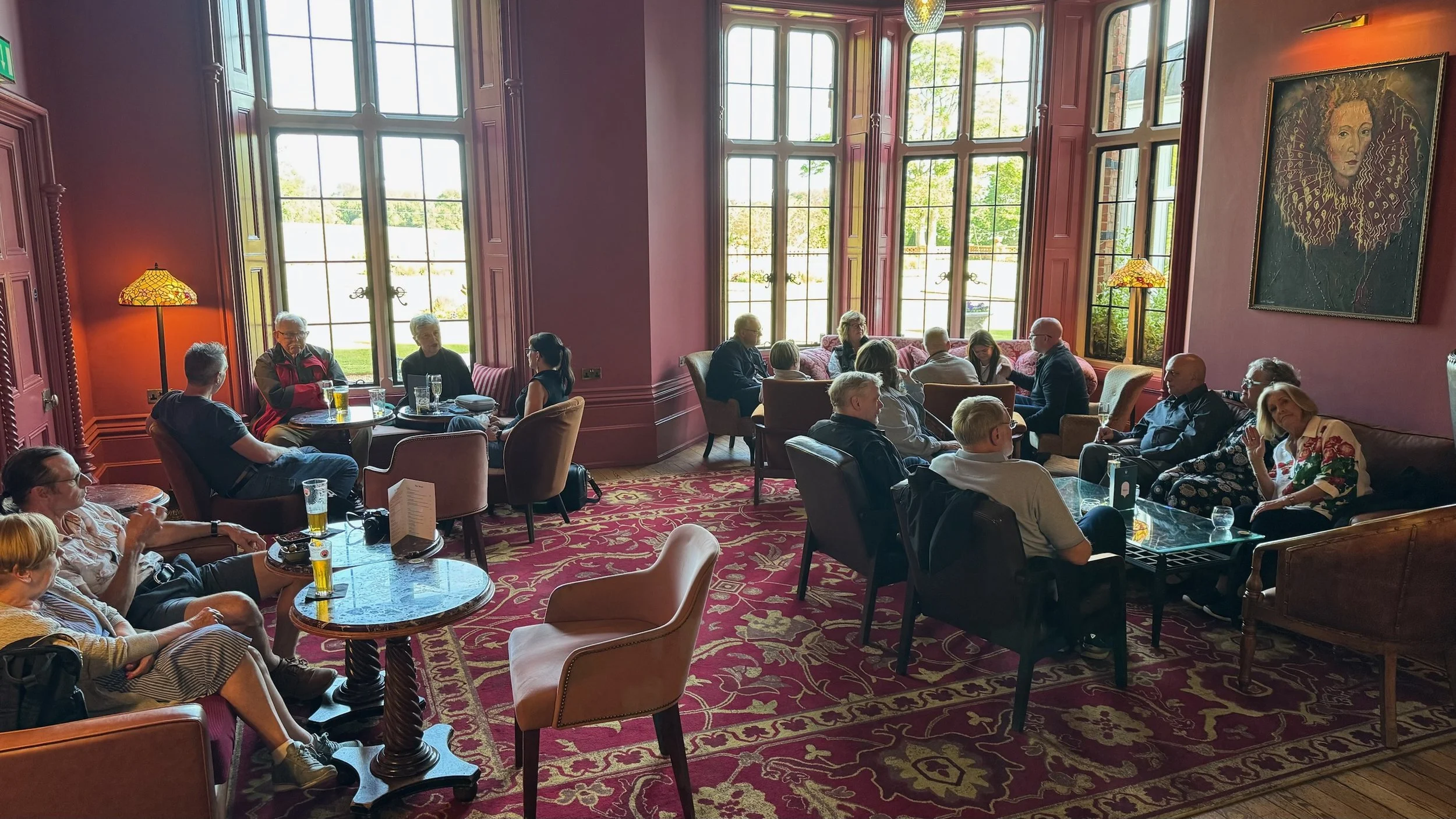 people siytting down in a grand bar talking and having drinks