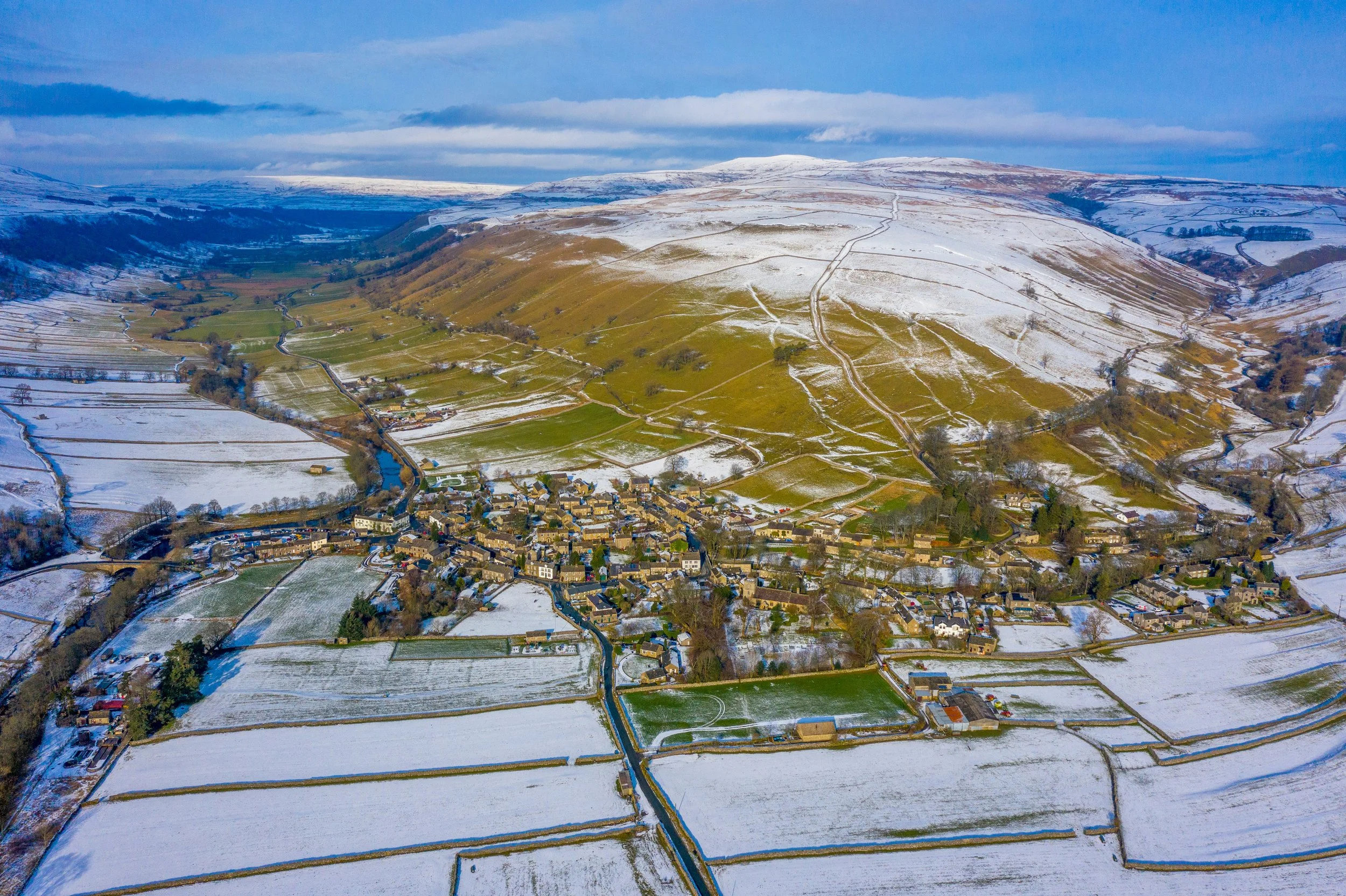 Kettlewell, Yorkshire Dales, from the air with snow on the hills
