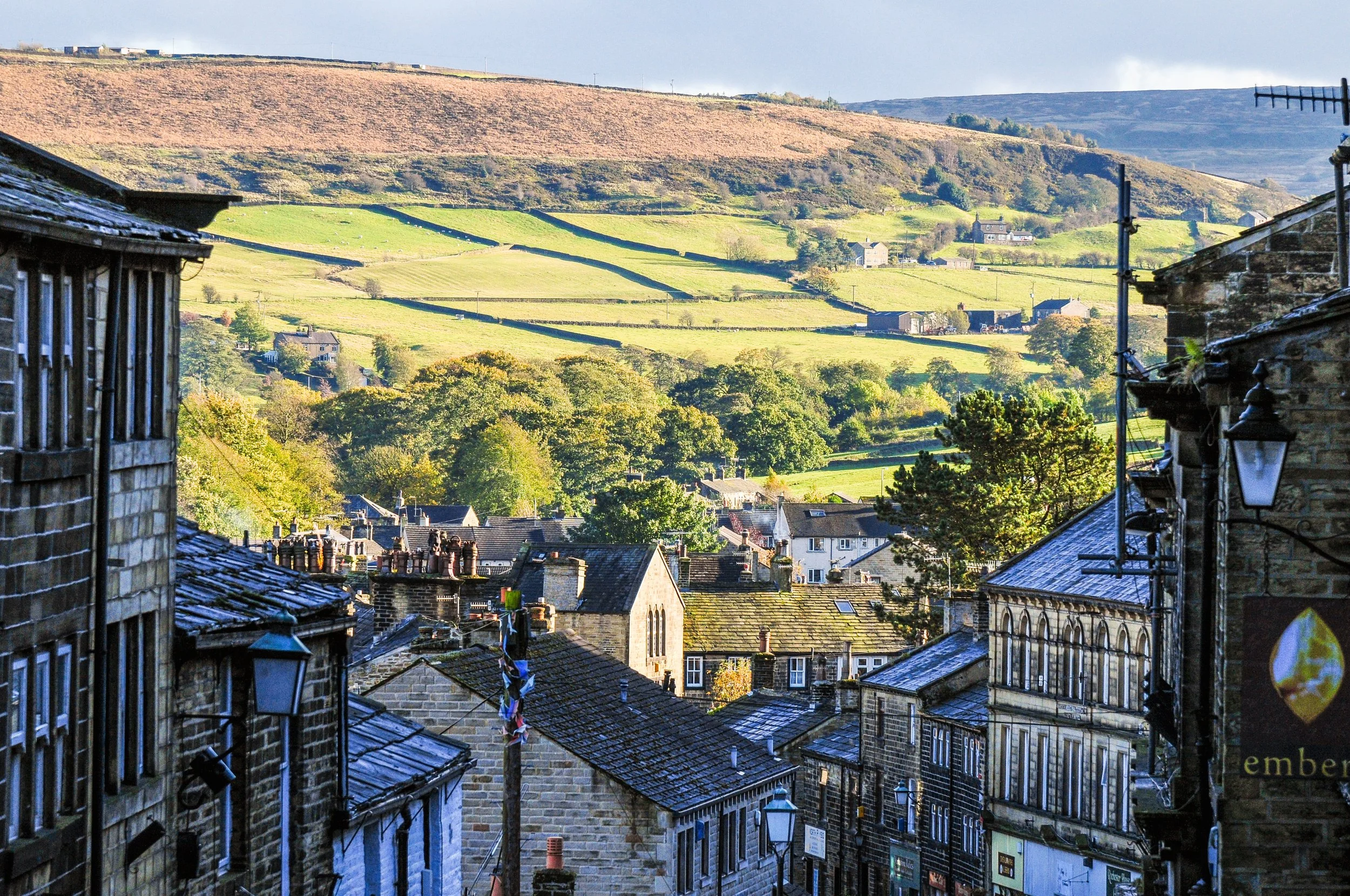 Haworth town steep streets with yorkshire dales in teh background