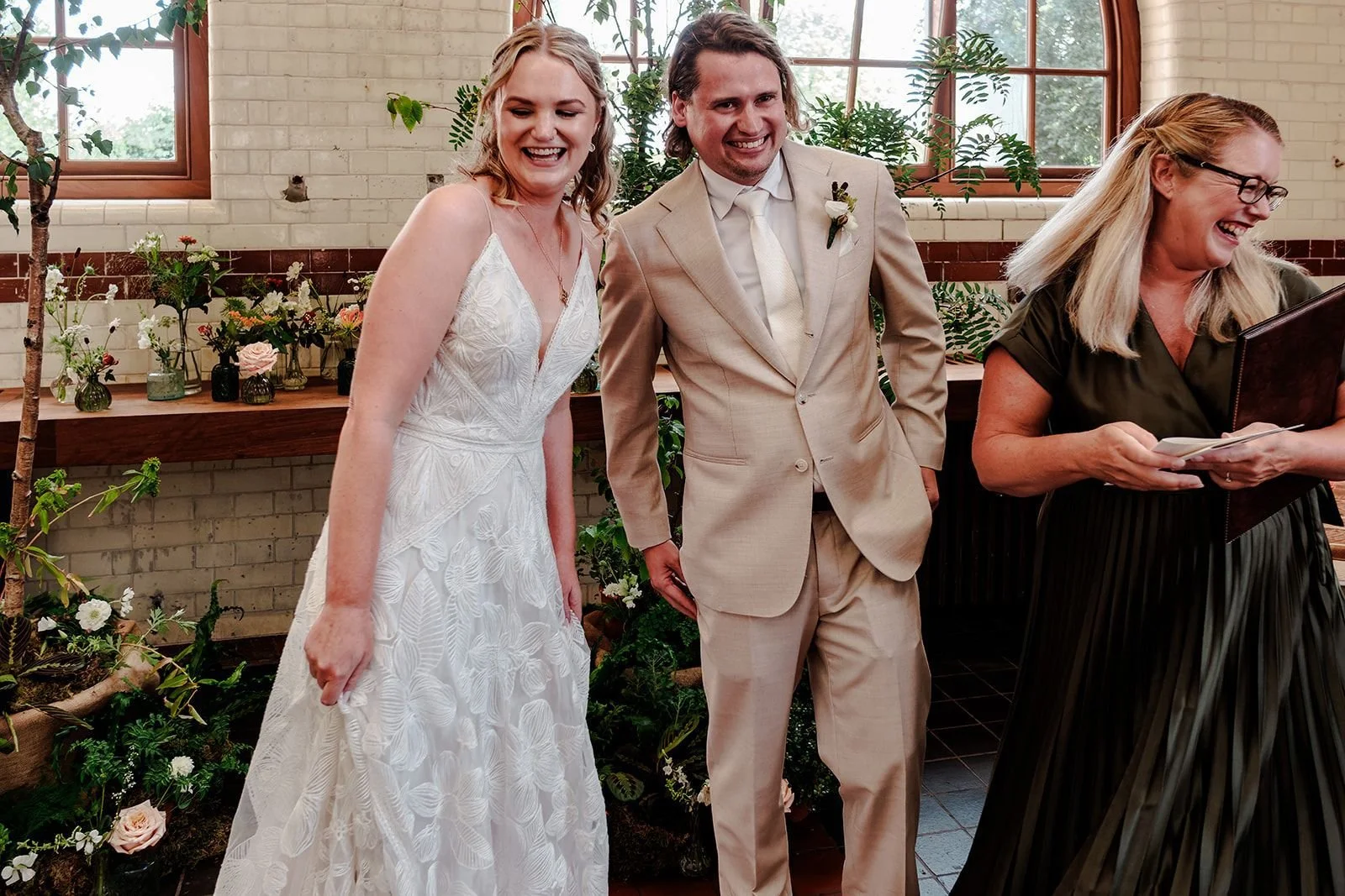 Couple and Celebrant Rachel Bellon laughing during ceremony at Walthamstow Wetlands