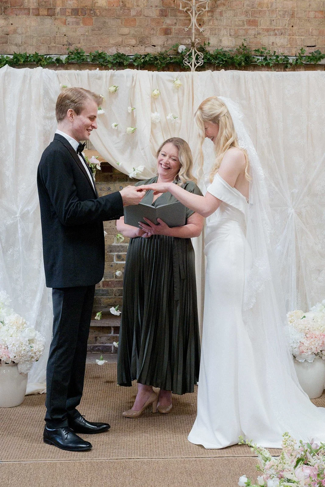 Couple exchanging rings with Celebrant Rachel Bellon at Botley Barn