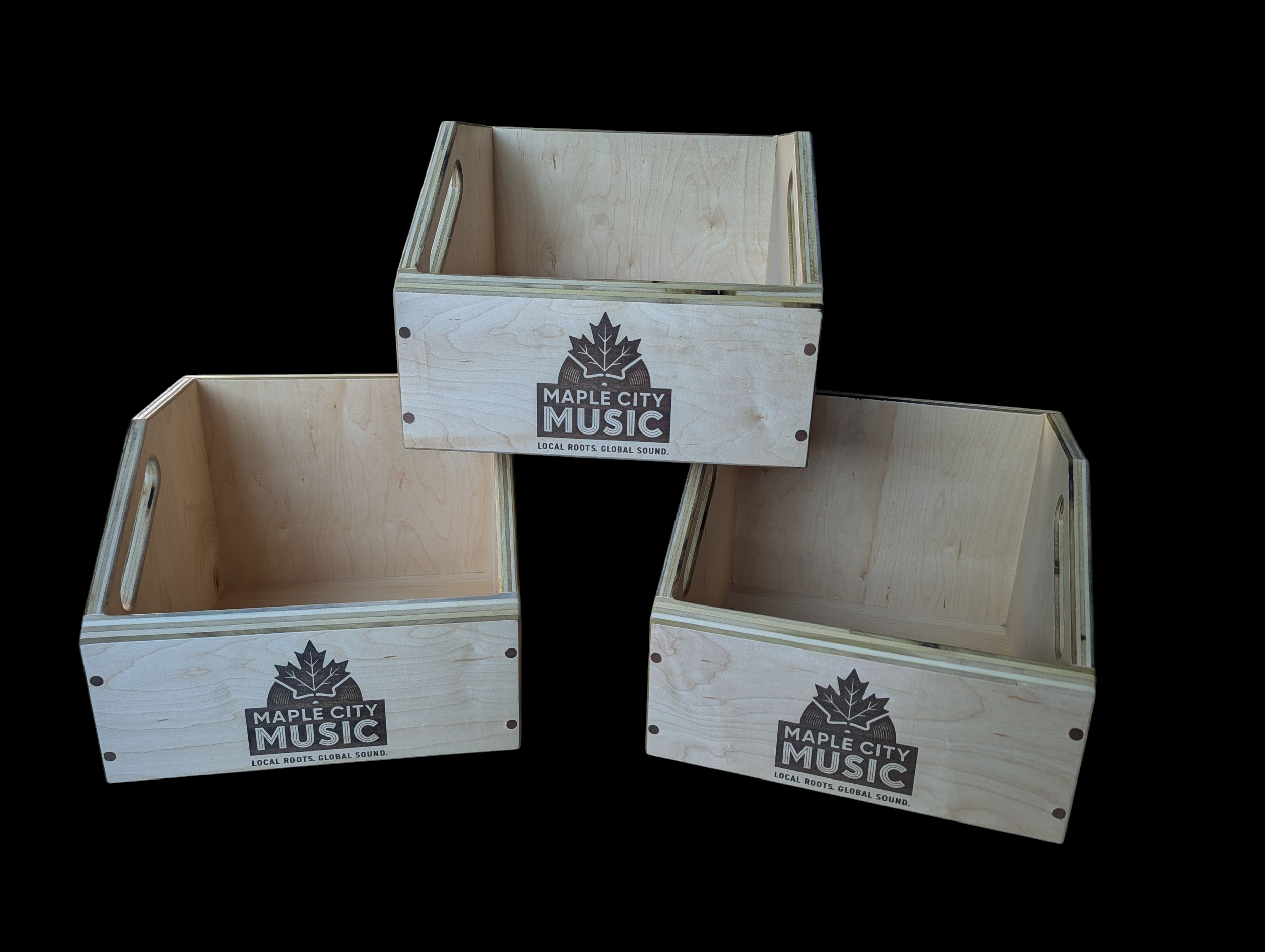 Three wooden crates with Maple City Music logos on a black background.