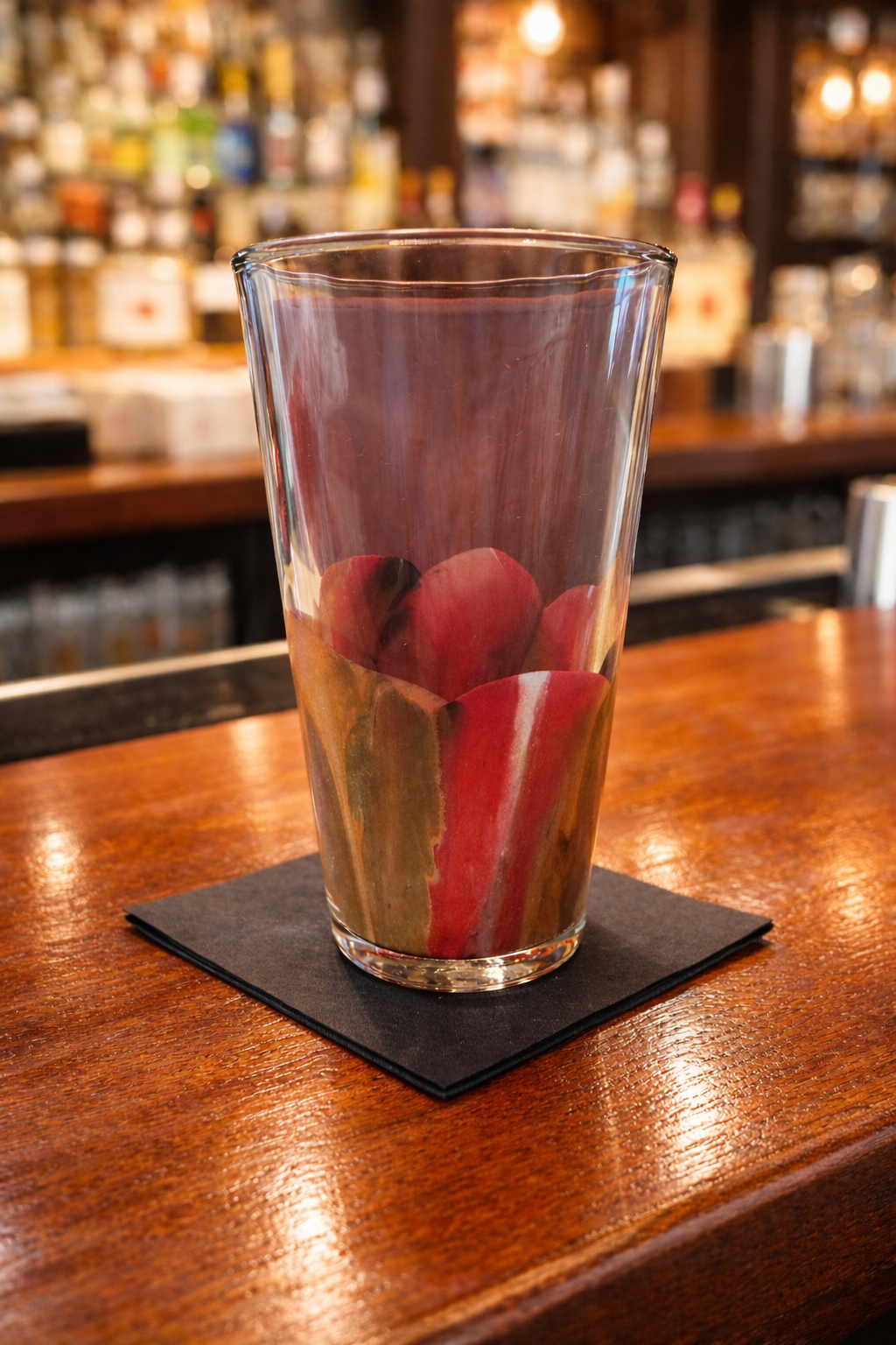 Artistic pint glass on bar counter.png