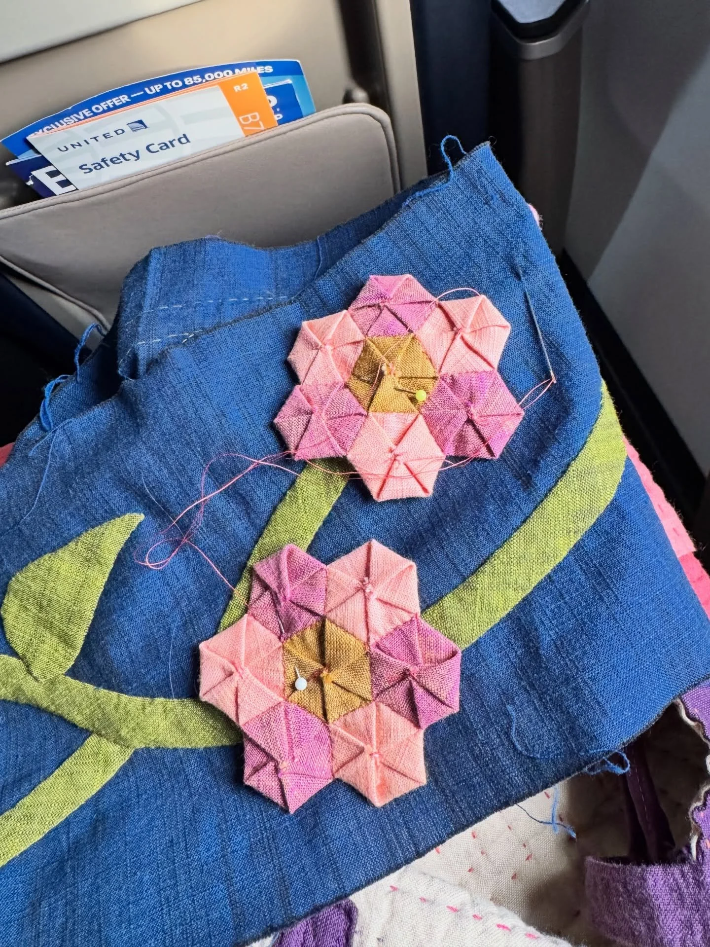 I tried the technique of turning a circle into a hexie, and it worked great! I don&rsquo;t know that I&rsquo;d do a whole quilt this way, but it makes for an adorable flower. 

I absolutely love stitching while traveling. I bring my blue Karen K Buck