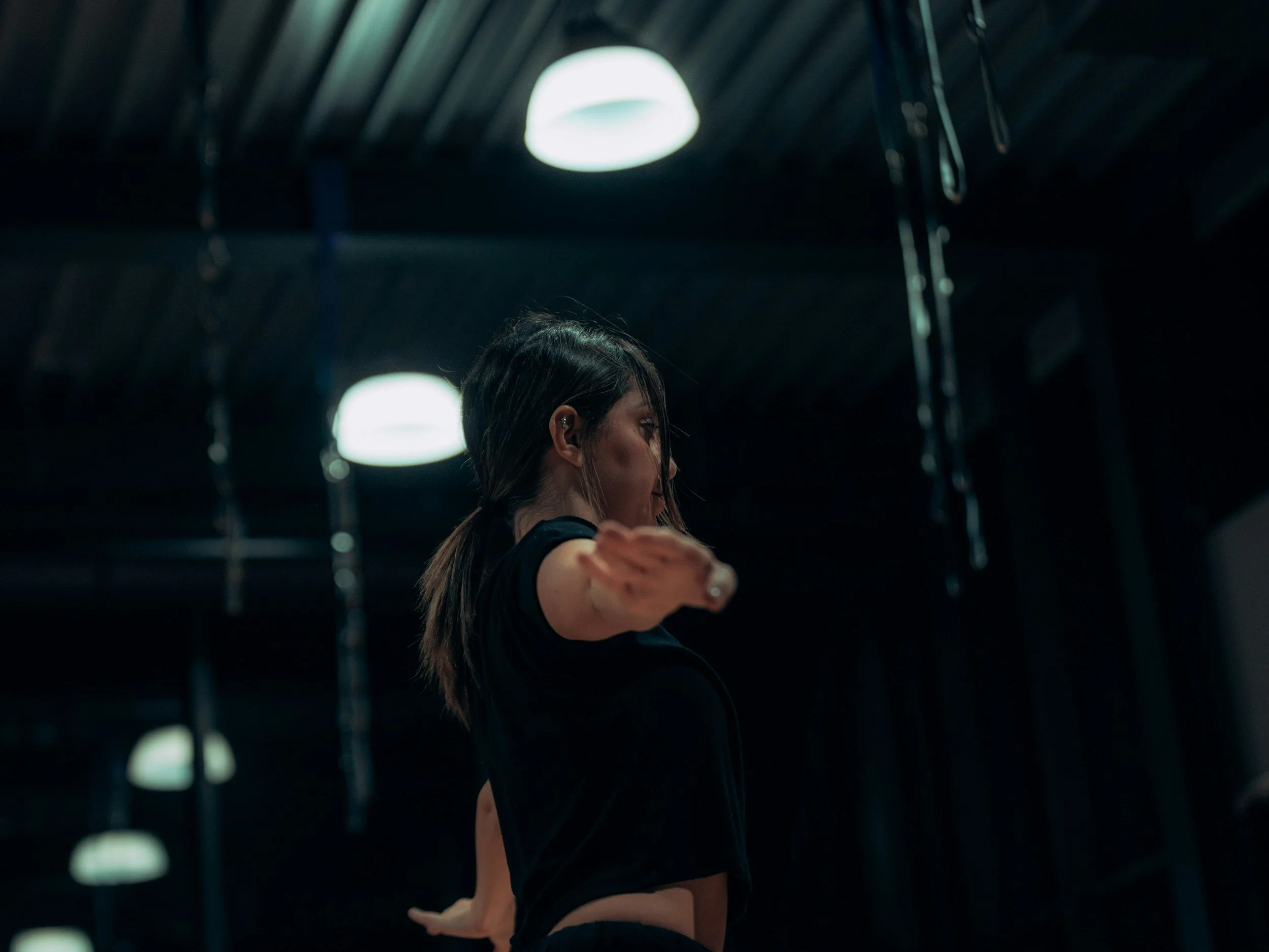 Dancer in black top from the side