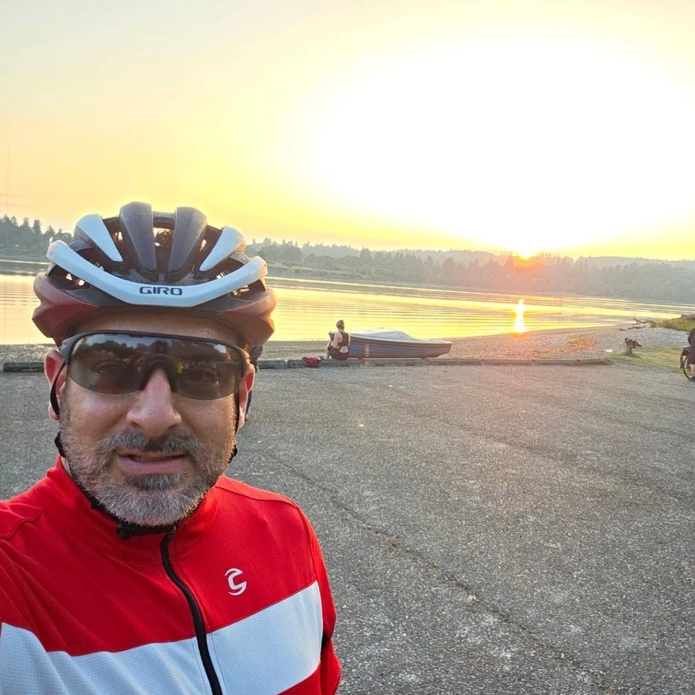 Cyclist selfie at sunrise by waterfront