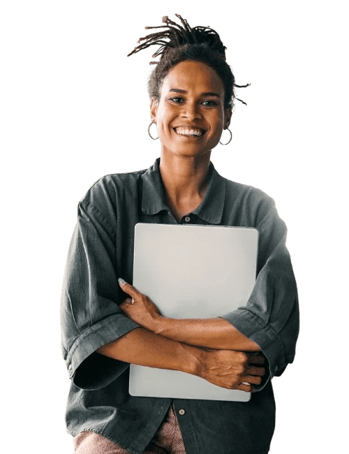 Smiling woman with dreadlocks holding a laptop, wearing a dark gray shirt, against a black background.