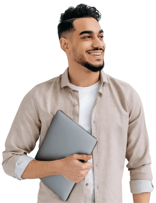 Young man smiling, holding a closed laptop, wearing a light-colored shirt and white t-shirt, against a plain background.